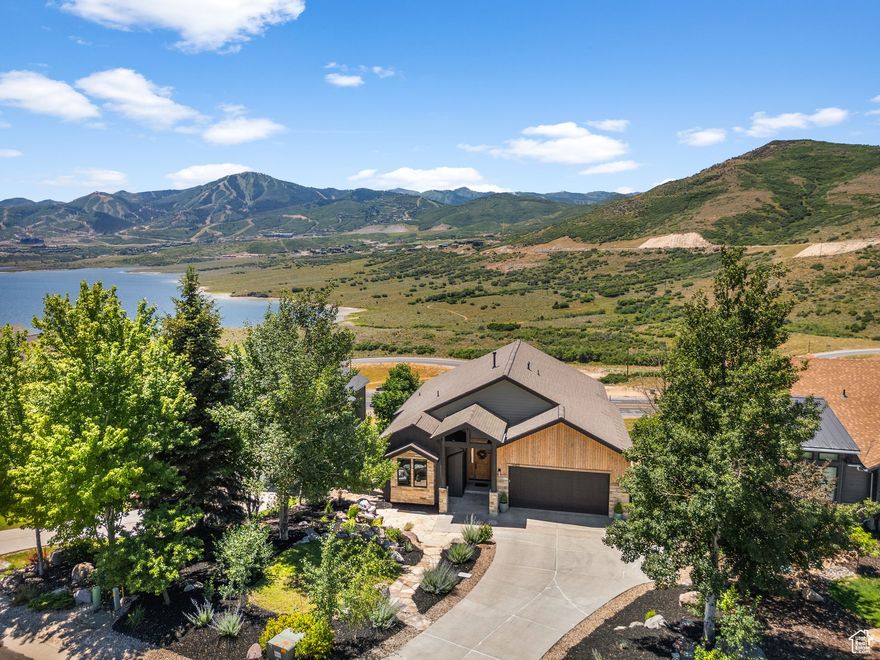 This completely remodeled four-bedroom, four-bathroom home delivers elevated mountain contemporary design with panoramic Jordanelle and Deer Valley views.  The open floor plan features vaulted ceilings, hardwood floors, and walls of windows that frame those stunning mountain views. Completely remodeled and upgraded The gourmet kitchen includes a waterfall island flows seamlessly into the great room with fireplace-perfect for entertaining or quiet evenings.