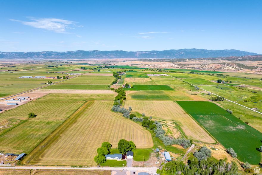 Situated in the heart of Sanpete County, this thirty-acre hay ranchette offers a unique opportunity to own your own farm with open pastures, Pleasant Creek running directly through your property, and the potential for additional income or alfalfa cultivation. The property features unobstructed mountain views, mature shade trees, main level living and proximity to town while maintaining seclusion. The area is home to an abundance of wildlife, including deer, hawk and beaver. The property has recently undergone a thorough cleanup of debris and non-organic materials. Included are Water Right 65-2223 for the private well and 35 shares of Pleasant Creek Irrigation, as well as the water wheel lines for the alfalfa crops. Approximately 24 acres are dedicated to alfalfa, with the south crop planted in 2023 and the northwest crop planted approximately 5 years ago. Each cut yields roughly 100-140, 3x3 bales, weighing 800-850 lbs., with three cuts per season, weather and water permitting. A current lease agreement is in place for the emblements, excluding the first cut of Spring 2025 from the sale. The lessee has expressed interest in renewing the lease for the remainder of the 2025 season if the property remains on the market or if the new owner chooses to continue leasing the crops. All information within is provided as a courtesy only. Buyer and Buyer's Brokerage are advised to complete their own due diligence. Square footage figures are provided as a courtesy estimate only and were obtained from tax records. Buyer is advised to obtain an independent measurement. Property and lot lines are shown as approximate. Also listed as a residential listing, MLS 2060101.