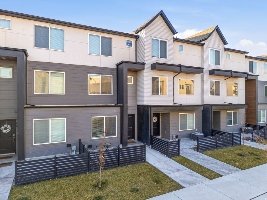 This modern, multi-level townhome is located in a highly desired neighborhood south of Pioneer Crossing in American Fork, offering a smart and flexible layout filled with natural light. The entry level features a versatile flex room or bedroom paired with a full bathroom-perfect for guests, a home office, or additional living space.  The second level showcases an open-concept family room and kitchen with 9-foot ceilings and large windows that create a bright, inviting atmosphere. The kitchen is finished with stainless steel appliances, a gas range, quartz countertops, and laminate flooring that flows seamlessly through the kitchen, dining, and family room-ideal for everyday living and entertaining.  The third level includes two spacious bedrooms, highlighted by a primary suite with a private bath and walk-in closet, along with a junior suite featuring its own full bathroom. A conveniently located laundry closet completes this level.  Additional features include a one-car garage, ample parking on both sides of the home, and a large unfinished underground storage area beneath the home-perfect for storing seasonal items, gear, and more. Enjoy newer appliances, expansive windows that flood the home with light, and access to community amenities including a clubhouse and pool. Situated just south of Pioneer Crossing, this location offers excellent accessibility while maintaining a neighborhood feel.  Tenant occupied with a lease in place through April 30, 2026.