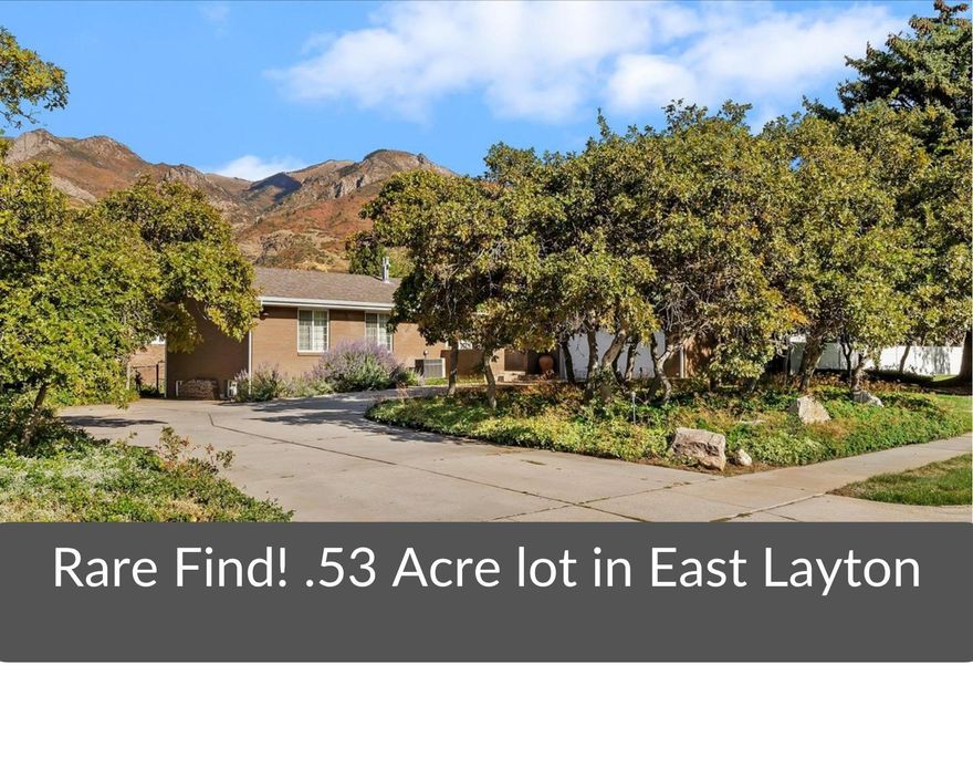 This exquisite home is truly one-of-a-kind! Nestled on a sprawling .53-acre lot in a highly desirable East Layton neighborhood with easy access to HWY 89 and Adams Canyon trails. Step inside and fall in love with the Mid-Century Modern architecture blended seamlessly with tasteful updates throughout. Primary suite is beautifully updated with a double-sink vanity, gorgeous shower with euro-glass door and an extra-large walk-in closet. Convenient main-level laundry and newer flooring, fresh paint, and dimmable recessed lighting bring comfort and style together. This home is as practical as it is beautiful, with two newer furnace/HVAC systems (one for each level), a water softener, newer roof, soffit, fascia, and rain gutters, plus a maintenance-free brick exterior. The open-concept kitchen offers picturesque views of the park-like backyard-a private oasis of mature trees, scrub oak, and vibrant perennials, perfect for parties, or even weddings! Additional features include a large storage shed, L-shaped driveway, and RV parking. Don't wait, homes like this don't come around often!