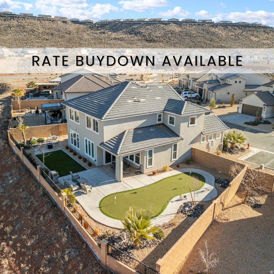 **This house comes with a REDUCED RATE as low as 5.875% (APR 6.176%) through List & Lock. This is a seller paid rate-buydown that reduces the buyer's interest rate and monthly payment. Terms apply. Click on QR code in photos for more info.** This premier 5-bedroom, 5-bathroom nightly rental is a masterclass in vacation luxury, meticulously designed to maximize both guest experience and investment potential. The heart of the home is a sprawling main-floor gathering space anchored by a custom kitchen featuring quartz countertops, a gas range, and a large walk-in pantry. The main level is also home to a luxurious master suite, boasting a large walk-in closet and an ensuite bathroom with dual vanities and an oversized shower. Upstairs, the entertainment continues in a second family room filled with arcade games and toys, alongside a second laundry room and three additional bedrooms-each with its own private bathroom. Even the garage is part of the fun, boasting a clean epoxy floor, a ping-pong table, and a full stock of toys for all ages. The true showstopper is the backyard oasis, specifically engineered for outdoor living with maintenance-free artificial grass, a large covered patio and additional palm trees were added. This space features three distinct sitting areas perfect for large groups, a gas fire pit, and BBQ. The private amenities are unparalleled, including a relaxing hot tub, a professional putting green, and a custom wiggle car track that makes this property a standout in the rental market. Beyond the home, guests enjoy world-class community perks such as a lazy river, water slide, swimming pool, additional hot tubs, pickleball courts, and extensive storage for RVs, ATVs, and UTVs. This turn-key property is an incredible opportunity to own a high-performing asset in a premier resort destination. Here is the link for the nightly rental https://www.stgeorgeutahvacationrentals.com/rentals/paseos-on-the-green/