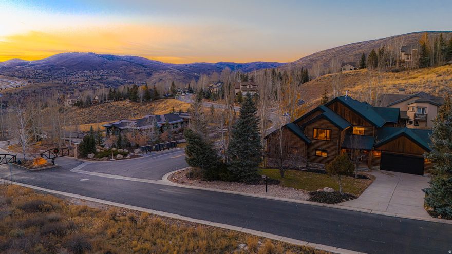 200K PRICE REDUCTION! Perched high atop Jeremy Ranch on a rare corner lot, this fully reimagined 2025 mountain-modern log home blends timeless alpine character with contemporary luxury. Situated in one of Park City's most coveted neighborhoods, the residence captures unobstructed panoramic views of Park City, Canyons, and Deer Valley ski resorts from a serene, private setting at the top of Daybreaker Drive.  A comprehensive 2025 transformation infuses the home with modern comfort and refined design while honoring its log-home heritage. Every detail has been renewed-new windows, designer lighting, premium flooring, fresh interior and exterior paint, and updated electrical throughout-creating a home that feels both sophisticated and welcoming. The vaulted great room showcases signature log-beam craftsmanship and a dramatic stone fireplace framed by sweeping mountain views that fill the space with natural light.  The gourmet kitchen pairs luxurious Calacatta quartz countertops with premium appliances and beautifully refinished cabinetry, offering an elegant yet functional workspace that harmonizes with the home's warm wood tones. Five spacious bedrooms and three and a half designer bathrooms provide comfort for family and guests alike. The main-floor primary suite is a true retreat, featuring a private balcony, spa-inspired bath, and generous closet space.  Downstairs, a large entertainment lounge invites relaxation with a pool table, second fireplace, and space for movie nights or gatherings. The lower level also includes a private Au Pair or in-law apartment with its own entrance-ideal for guests, caretakers, or multigenerational living. A versatile bonus room can serve as a spa, sauna, gym, or additional bedroom depending on your needs.  Outside, the expansive deck and landscaped yard showcase unforgettable sunsets over the Wasatch Range. The enormous three-car garage plus extra guest and camper parking offer exceptional space for vehicles, toys, and gear. Within the Park City School District and minutes from world-class skiing, golf, hiking, and dining, this exceptional log-home retreat embodies the perfect blend of authentic mountain beauty, modern convenience, and timeless design-a rare find in one of Park City's most exclusive settings.