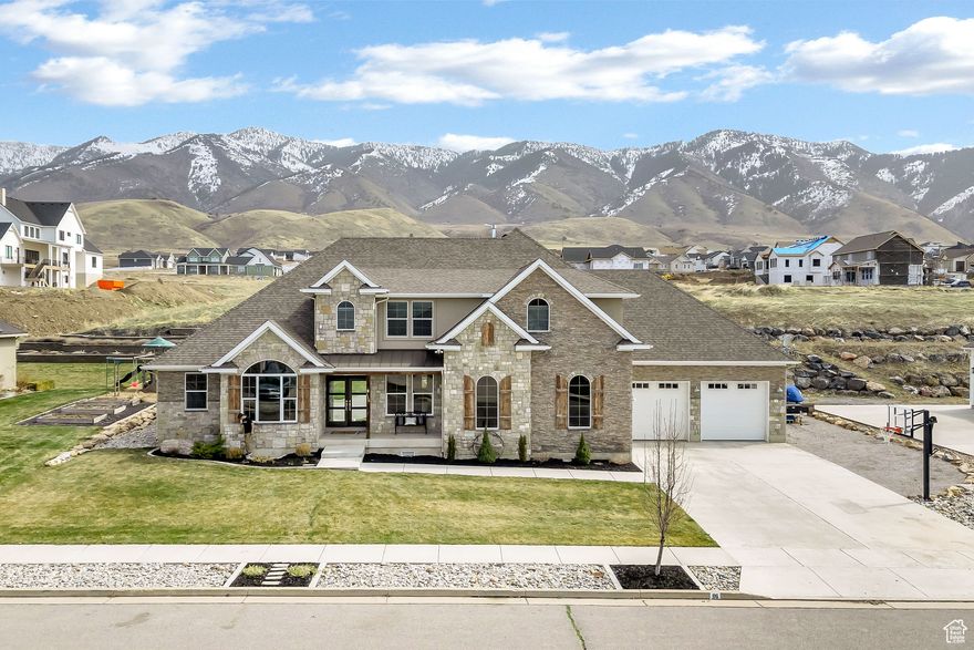 Price Improvement! Welcome to this custom built breathtaking mountain modern masterpiece offering almost 6,000 sq. ft. of thoughtfully designed living space. The moment you set foot inside you know you've entered a true dream home. This 8 bedroom, 5 bathroom estate seamlessly blends contemporary elegance with exceptional functionality. Step inside to soaring ceilings with 2 story windows that frame the terraced backyard. The chefs kitchen boasts premium appliances such as a Double Refrigerator, Double Ovens, Double Dishwashers all surrounded by custom cabinets. There is a space to add your own custom ice maker. Oversized island with sink is perfect for entertaining. The large butlers pantry is complete with built in shelving and sink which will keep everything organized. The mudroom with built in lockers, charging stations and a drop zone is the perfect area to keep a busy family organized. The luxurious primary suite is a private retreat, featuring a spa-like bath complete with a steamer shower and an expansive walk-in closet. Enormous main floor Laundry room with stunning marble countertops and granite Island, built in custom cabinets and sink. There is even a laundry chute from upstairs that leads directly into the laundry room on the main floor. Great room features a beautiful stone fireplace, custom mantle and built in shelving. Adding to the detail of this beautiful home is 100+ year old barn wood from the area featured on the pantry door, fireplace mantle, beams and outdoor shutters. Upstairs features a large living area with built in shelving, 4 large bedrooms with a raised loft and a hidden door. Both baths feature double sinks. Basement has 10' ceilings with 3 large bedrooms and bathroom. The unfinished part of the basement is completely sheet rocked and ready for paint and carpet. The basement is plumbed and ready for a complete kitchen with an island. Lots of storage with a cold storage under the front porch area. Enjoy outdoor entertaining on the extra large covered patio which makes for great entertaining or family time. Ring doorbell with spotlight cameras and raised garden area in the terraced backyard. Oversized heated garage with a washer/dryer hookup and sink. Lots of built in shelving in garage. Room for RV parking outside the garage in the gravel area. This dream home remains comfortable in every season with double furnaces, double AC units along with a boiler which provides In-floor heat in basement, garage and instant hot water. This home provides the ultimate blend of relaxation in a luxury family estate.