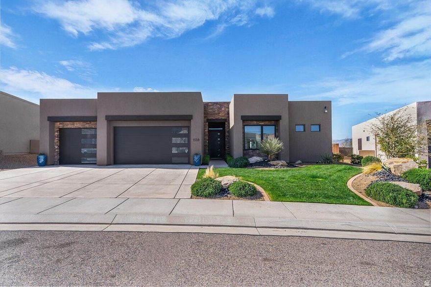 Inspired by Parade of Homes design, this exceptional residence offers a perfect blend of luxury, style, and elevated desert living. The home showcases high-end upgrades throughout, including thick-cut quartz countertops, custom lighting, designer flooring, and beautifully crafted tile work. Positioned on a rare view lot, you'll enjoy breathtaking vistas of St. George and Snow Canyon, with abundant natural light filling the open-concept floor plan. The chef-inspired kitchen flows seamlessly into the living and dining areas, creating an ideal space for both everyday living and entertaining. Cascading rear sliding glass doors open to a private backyard, offering effortless indoor-outdoor living. The primary suite is a true retreat, perfectly positioned to capture the incredible views, while an oversized 3-car garage with epoxy floors completes this stunning home. Located in the highly sought-after Ledges of St. George community, the home offers close proximity to Snow Canyon and sidewalks that lead to the Chuckwalla bike and running trail. With an affordable HOA that covers lawn maintenance, residents enjoy the ease and convenience of low-maintenance, resort-style living. Buyer to verify all information, deemed reliable, however buyer to verify all info including utilities, rental restrictions, and HOA information if applicable.