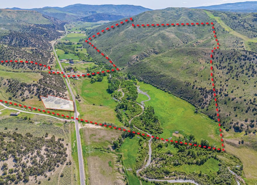 A rare legacy offering in the heart of Summit County, Chalk Creek Meadows Ranch is a true Western treasure, a 565-acre ranch along Chalk Creek that seamlessly blends working land, private recreation, a hunting paradise, and unrivaled natural beauty in one contiguous block. This is the kind of opportunity that seldom comes along, a private and adventure-rich property that speaks to the soul of the ranching lifestyle. Encompassing every coveted land type, from irrigated hay fields with senior water rights to sub-irrigated meadows, dryland farming ground, and hundreds of acres of mountain terrain. This ranch is a dream canvas for those who seek both privacy and purpose. Chalk Creek, a major tributary of the Weber River, winds through the ranch for over half a mile, offering exceptional private fishing for large brown trout and native Bonneville cutthroat. This scenic riparian corridor is framed by lush meadowlands and backdropped by rising foothills, teeming with wildlife and dramatic views from approximately 6,000 to 7,000 feet in elevation. Your private hunting and fishing grounds, with deer and elk being a regular sight in the hayfields and hillsides, and turkey hunts in the spring and fall seasons, offer further adventure. The property is eligible for highly desirable hunting tags through the Chalk Creek unit, with bull elk and turkey tags available over the counter and buck mule deer tags through a high-odds draw. The setting provides sweeping views of the ranch's meadows, fields, and private water, and is supported by full utility infrastructure, including power, natural gas, septic, and culinary water from a spring, including three water rights. Located just 7 miles east of I-80 and the charming town of Coalville, the ranch is easily accessed year-round via paved Chalk Creek Road. 30 Minutes from Park City, and less than one hour from the Salt Lake City International Airport or the Heber Valley Airport. Zoned Agricultural-20, which allows for a base density of one residential unit per 20 acres, with a one-acre minimum lot size.