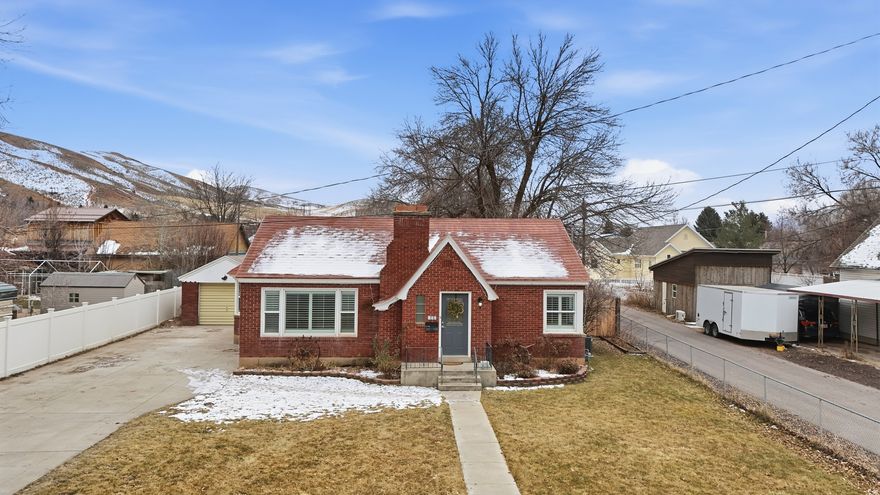 Experience the quintessential small-town Utah lifestyle in this darling move-in ready brick bungalow located in the heart of Morgan. This home perfectly captures a "cute and quaint" aesthetic while offering modern updates and a massive yard that provides endless options to expand or enjoy as your own private outdoor park.  New Flooring & Carpet: Featuring brand-new flooring in main areas and plush new carpet in the bedrooms.  Updated Kitchen: Comes equipped with a new disposal and a full suite of appliances all less than 2 years old, which the owners are leaving as an added bonus!  Fresh Bathroom: Includes a stylish vanity installed just months ago.  Year-Round Comfort: Stay cool with a recently installed A/C unit.  Quality Finishes: Every window is outfitted with high-end, new shutters for privacy and style.  The Exterior: The true "wow" factor of this property is the outdoor living space. The oversized lot is a gardener's dream with a peach tree, apple tree, raspberry bushes and a massive shade tree creating a cool canopy -- perfect for summer afternoons and BBQ's!  Durable Protection: The home features a sturdy metal "shingle" roof, stamped metal to mimic tradition wood shakes. Giving the roof a more classic architectural appearance than the standing-seam metal panels. This type of roof has a significantly longer life-span that standard asphalt shingles.   Unbeatable Location: Situated in a wonderful, friendly neighborhood, you are within easy walking distance to Morgan Elementary, Middle, and High Schools. Enjoy the peace of a mountain-valley community with the convenience of being close to the library, local parks, and the Wasatch front.  Square Footage: 1,228 (Buyer is advised to obtain an independent measurement for accuracy).