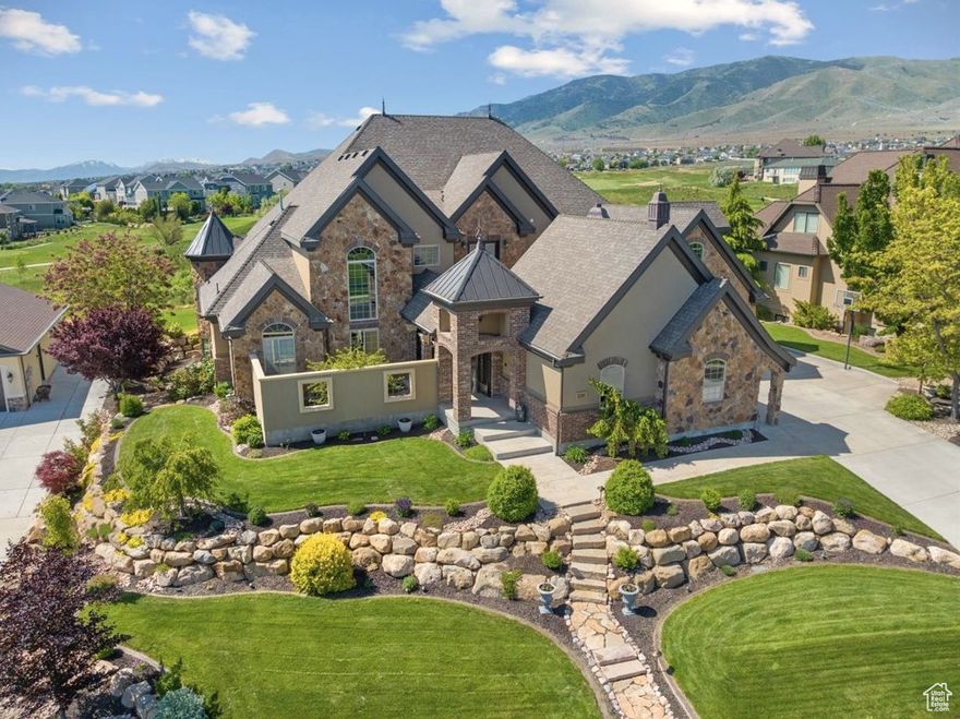 Updated ultra-custom masterpiece, located in a private lakeside resort community, backing Talon's Cove Golf Course with views of Mount Timpanogos, Utah Lake and one of the most scenic fairways in Utah. Prime location, timeless design, and quality craftsmanship with attention to every detail make this one of Saratoga's finest and most uniquely impressive homes, which must be seen in person to fully appreciate. The main level is ideal for gatherings with a grand entry, extensive great room with soaring windows and ceilings, gourmet kitchen with a butler's pantry, and formal dining. The main-level primary suite extends into the southeast tower, providing a sanctuary space with panoramic views, and includes a spa-like bathroom, and an expansive closet with built in shoe racks, drawers and an island, along with secondary laundry hookups. Additional main-floor highlights include a two-story executive office/den/library with floor-to-ceiling windows, built-in workspace and bookshelves, and coffered ceilings; a mud room area with abundant cabinetry for storage.; and an extensive laundry room with flex space for crafts, projects, home business or other use.   The daylight basement is a wonderland for all ages. Children (or the young-at-heart) might prefer to skip the stairs and access the basement by taking a concealed slide from Rapunzel's Tower to Cinderella's Castle on the way to Snow White's Cottage, and passing by the Beast's Den before exiting into a vintage English street setting (Harry Potter themed occasionally) with a parlor leading to a luxury theater including stadium seating and Dolby Atmos surround sound for a true cinematic experience. Other basement features include a massive family room with space for a wide variety of recreational activities; a corner tower room with panoramic windows, a guest bedroom and bathroom suite; a large additional bedroom or workout area; abundant storage spaces, and a walkout exit with French doors.   The upstairs level features two bedrooms with full ensuite bathrooms, a spacious additional bedroom/bonus room above the garage, a large loft with access to the covered deck and a secret lounge accessible through a built-in bedroom bookshelf.  The corner firepole (with restricted access) will get you from upstairs to the main level quickly in the event of a fire (or if you are just running late for dinner).   Exterior features include a private inner courtyard with a garden, waterfall, and full-size gas or wood burning brick fireplace; a covered deck and patio with postcard-worthy views; customizable landscape lighting to accentuate the beautiful and mature landscaping; in-ground trampoline; 43 solar panels, providing abundant clean electricity at a nominal cost; spacious 4-car garage spanning over 1,000 sf.; RV / boat parking, etc.   Comfort and livability features include radiant floor heat in select tile areas, reverse osmosis water system, instant hot water, integrated humidifier, whole home intercom system, soundproofing, and four bedrooms with full ensuite bathrooms.    Experience the incredible lifestyle this home and community provide. Unique and extensive HOA amenities include a private boat marina; multiple lakefront clubhouses with exercise facilities, game rooms, swimming pools and spas, including a one-of-a-kind year-round natural hot-springs pool & spas; multiple parks, including a lakeside park with a stream, beach volleyball, playground, large pavilion with an outdoor fireplace; scenic walking trails along Utah Lake, etc. This remarkably serene atmosphere is only minutes away from extensive restaurants, shopping and other conveniences. New roof installed in May 2025. Home warranty included with sale. To view a video tour and a point/click 3D property tour click "View Tours" on the listing, or visit: https://my.matterport.com/show/?m=1m8i9zUQHD8 (for a 3D tour) or https://vimeo.com/964750567?share=copy  (for a Video Tour).  Note - portions of home were painted and updated after t