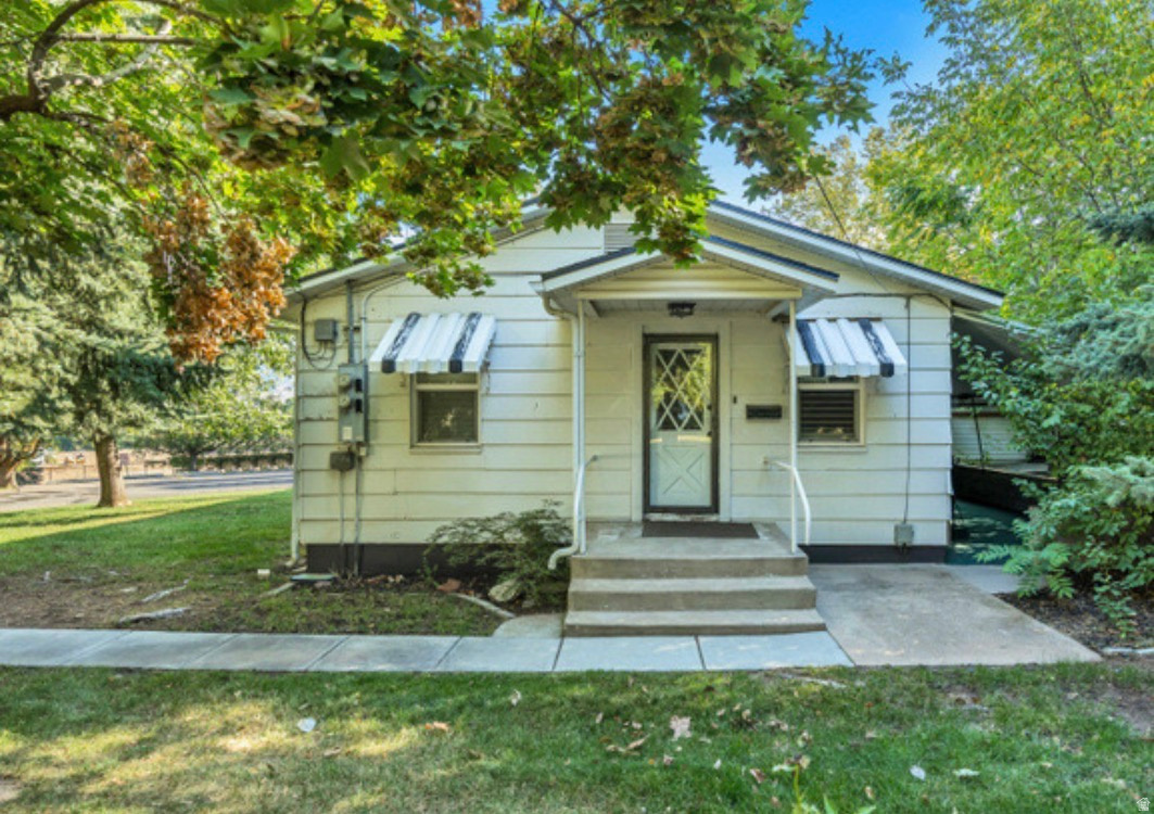 White siding exterior with a covered porch entry