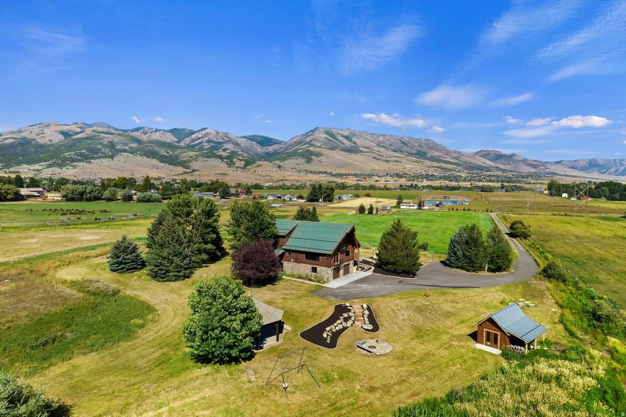 Seller Financing Available at 5.5% interest! This Field of Dreams property in Eden, Utah, overlooks Nordic Valley Ski Resort and spans 6.64 irrigated acres, offering rare privacy, open space, and breathtaking mountain views with no close neighbors. Newly renovated, this is a true retreat where peace, scenery, and possibility come together. Inside, the home features a spacious entry with wood floors, a beautifully designed kitchen with beamed ceilings and stone backsplash, and a dining area and living room that capture stunning ski-resort views. The main level includes a serene owner's suite with porch access and spa-like bath, while the upper level offers a versatile loft with balcony, an office, two additional bedrooms, and a full bath. A fully finished lower level provides a separate living space with its own kitchen, living room, bedrooms, laundry and bath- perfect for guests or multigenerational living. Outside, the 6.64 irrigated acres offer endless opportunity with a powered wood pavilion, fire pit, and multiple sheds, ideal for entertaining, animals, or future expansion. This is a place where space, views, and lifestyle come together-if you build it, they will come.