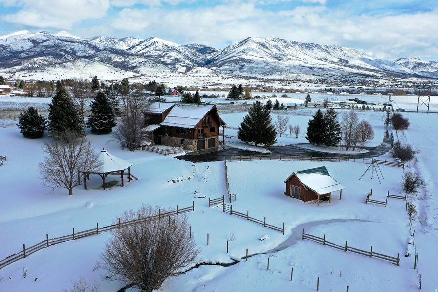 Seller Financing Available at 5.5% interest! This Field of Dreams property in Eden, Utah, overlooks Nordic Valley Ski Resort and spans 6.64 irrigated acres, offering rare privacy, open space, and breathtaking mountain views with no close neighbors. Newly renovated, this is a true retreat where peace, scenery, and possibility come together. Inside, the home features a spacious entry with wood floors, a beautifully designed kitchen with beamed ceilings and stone backsplash, and a dining area and living room that capture stunning ski-resort views. The main level includes a serene owner's suite with porch access and spa-like bath, while the upper level offers a versatile loft with balcony, an office, two additional bedrooms, and a full bath. A fully finished lower level provides a separate living space with its own kitchen, living room, bedrooms, laundry and bath- perfect for guests or multigenerational living. Outside, the 6.64 irrigated acres offer endless opportunity with a powered wood pavilion, fire pit, and multiple sheds, ideal for entertaining, animals, or future expansion. This is a place where space, views, and lifestyle come together-if you build it, they will come.