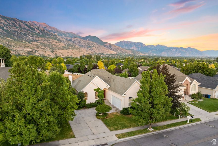 UNREAL VIEWS OF MOUNT TIMPANOGOS is not the only thing that makes this rambler a showstopper: Single ownership, Great Layout, 2 Kitchens, 2 Laundry Rooms, 2 Living Rooms, and 3 fireplaces... and priced to sell! Set at the base of Mt. Timp with the dreamiest backyard views (no backdoor neighbors!), this gem is overflowing with charm and opportunity, in a phenomenal location. Inside, the layout makes sense, with three bedrooms on the main level, including a spacious Primary Suite with a fireplace, large walk-in closet and roomy bathroom! Downstairs, you'll find two more bedrooms, an extremely large second living room, and a fully functioning second kitchen--ideal for hosting, hobbies, or whatever life throws your way. Functionality reigns supreme with laundry rooms on both the main level and in the basement, along with tons of storage (cold storage & regular storage room(s)), AND AN ADDITIONAL framed, unfinished room ready to become a home gym, extra storage room, or a 6th bedroom. BONUS: UPDATED HVAC, WATER HEATER, ATTIC INSULATION FOR EFFICIENCY, AND PAD/ELECTRICAL FOR OUTSIDE GENERATOR!  The backyard feels like a little retreat, with fruit trees (cherry, apple, blackberry), mature shade, and that rare combination of being both spacious and quaint at the same time. This home has been deeply loved over the years--and you can really tell. Don't miss out!