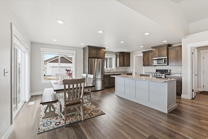 This beautiful 5 bedroom, 3.5-bathroom rambler offers over 3200 sq ft of spacious living  set on a generous .78-acre lot, it offers plenty of room to unwind, play, and take in the beautiful river views. Upgrades include: stained cabinetry, accent island, and granite countertops, sturdy LVP and tile flooring, grand master bathroom, ceiling fan, stylish custom railing. plumbing for a future soft water system, shelving in the garage, dog run and the additional kitchenette in the basement is perfect for potential mother-in-law suites or hosting dinner gatherings. This home gives a lifestyle you will love in Riverside, Utah.