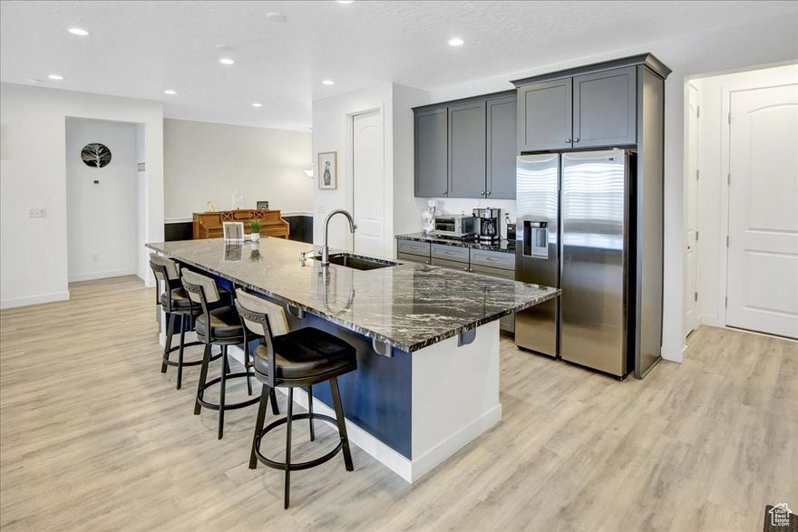 ** 40K PRICE IMPROVEMENT** SINGLE LEVEL LIVING! South-facing rambler, located in the Jackson community in beautiful Herriman. Minutes from Mountain View Corridor, TRAX lines, and the new Salt Lake Bees Baseball Stadium. The main level has soaring 10-foot ceilings, offering an open and spacious feel, while the basement provides 9-foot ceilings, making every part of this home feel expansive. The kitchen boasts a massive 12-foot island with bar seating, double ovens, a gas range, stainless steel appliances, granite countertops, and sleek LVP flooring that flows throughout the upper level. Beautiful plantation shutters throughout for a clean and timeless look. Primary bedroom with ensuite bathroom that offers double sinks, granite countertops, separate tub and shower, and WIC. The spacious, unfinished basement provides endless possibilities and features a built-in radon mitigation system, a tankless water heater, and a water softener. Step outside to a fully fenced backyard, perfect for privacy and pets, along with a covered patio. This home is move-in ready and designed for comfort, style, and practicality. Square footage figures are provided as a courtesy estimate only and were obtained from county records. Buyer and Buyer's agent to verify all information. Pre-approval letter from lender or POF must accompany all offers.