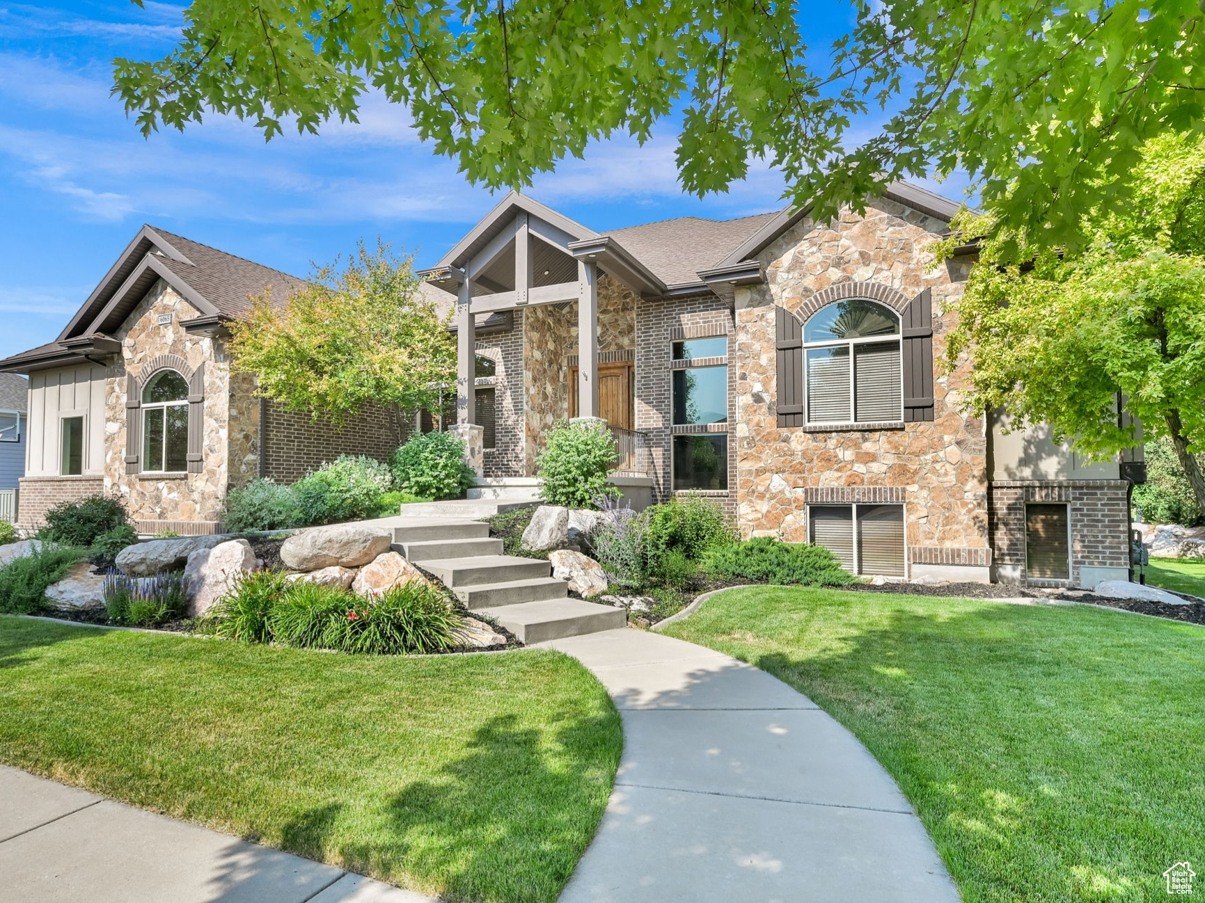 AN ASSUMABLE 2.5% VA LOAN IS AVAILABLE WITH QUALIFICATIONS. Welcome to this beautiful custom-home in the highly-sought-after Rollings Ranch neighborhood in Mountain Green. Luxury homes, tree-lined streets, walking paths, and hiking trails just out your front door makes this neighborhood a premier location in the area. The quality architecture, elegant landscaping, mature trees, lush lawn and exterior stone finishes provide all the curb-appeal you would desire from this 4,954 sf custom-built home. The quality and comfort of this home is apparent throughout. The vaulted ceilings, large custom beams and stone covered fireplace set the tone for the quality of the construction. The large, yet cozy, living room features oversized windows and french doors to bring in plenty of natural light and provide amazing views of SnowBasin and the Wasatch Mountains. The spacious covered deck offers plenty of shade for grilling, enjoying the outdoor dining area or just relaxing and taking in the mountain views. The main level owner's suite, home office with custom built-ins, main-floor laundry room and two additional bedrooms and bathrooms make up the main level. Downstairs is a formal living room, huge family room with an additional stone covered fireplace, more oversized windows, french doors to a covered patio, as well as an additional bedroom and bathroom. A large storage room and a large unfinished room in the basement provides massive amounts of storage space or the opportunity to customize to suit your needs. Maybe additional bedrooms, a home gym, another home office or just simply leave as a storage room. The three-car garage provides extra height and length allowing for plenty of room to store all of the toys. An additional pad alongside the garage provides an RV parking pad as well as a basketball hoop for some outdoor fun. This mountain community boasts a new retail center and Lee's Marketplace just a short walk or bike ride down the road. Mountain Green is a growing mountain town that is a mere 38 miles from Salt Lake City International Airport and is just minutes from Snowbasin and a short drive to Powder Mountain, Nordic Valley, several golf courses, and reservoirs! The home is located just 20 minutes to Ogden, and just a little over an hour to Park City. City close but country quiet!! The community feels like "Small Town USA" where folks still walk in the evenings and chat with neighbors. An assumable 2.5% VA loan is available with qualifications, see agent notes for balance and rate. The Square footage figures are provided as a courtesy estimate only and were obtained from County Records . Buyer is advised to obtain an independent measurement.