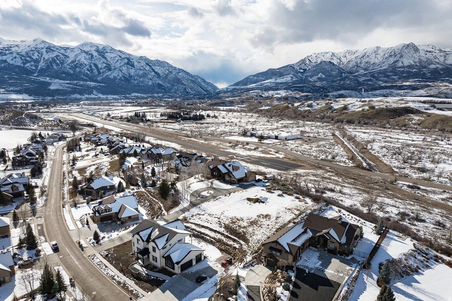 This is the one! The last remaining lot of its kind in The Cottonwoods with unobstructed views of Snowbasin. Perched above the Mountain Green Airport with no backyard neighbors, this rare parcel offers the privacy and elevation that defines exceptional mountain living.  Previous home build plans have been drawn and are ready for your vision. Available upon request. Or build your custom mountain home you've been dreaming of. Wake up to stunning Snowbasin views and enjoy evenings on your future deck overlooking the valley below. Utilities have been stubbed to the property. Minutes from Snowbasin and Wasatch Peaks, a short drive to Pineview Reservoir, 40 minutes to Powder Mountain, and 45 minutes from Salt Lake City International Airport. Private community trails are right out your front door for mountain biking, hiking, and daily walks. This is Mountain Green living at its finest.