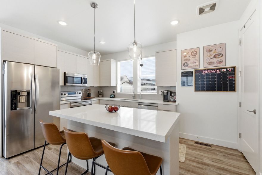 Welcome home to this bright and beautifully maintained 2020 end unit townhome, offering modern features, great natural light, and a convenient location near Daybreak.  Smart home features include a smart garage door, front door lock, Nest thermostat, and smart appliances. The home also features a tankless water heater,large closets, and slow close cabinetry in both the kitchen and bathrooms for a polished and functional finish.  Step out onto the balcony to enjoy views of the copper mine and surrounding landscape. You can also see the Wasatch front mountain range from the living room window. In the front, there's a large common green space with beautifully maintained landscaping perfect for to relaxing, walking pets, or gather with neighbors.  Located in a quiet, clean, and pet friendly neighborhood, this home offers quick access to Downtown Daybreak, Daybreak Lake, the new Daybreak Water Course, Mountain View Corridor, and plenty of nearby parks, shopping, and restaurants. Local favorite Biscotts Cafe is even within walking distance.