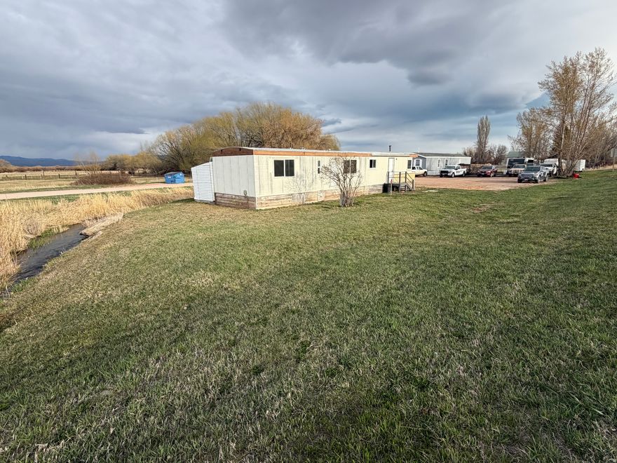 Mostly updated, roomy home in The Creek mobile home park in Paris, ID! Original home is 2 bed, 1 bath, but 3 more rooms were added on, giving potential for 4 or 5 bedroom house, or add a second bathroom and make a 3 or 4 bed, 2 bath! New flooring, interior paint, most light fixtures, baseboards, kitchen sink, toilet, and more! Not to mention the serene location of this lot, with lots of frontage on the beautiful Paris Creek, keeping you insulated a ways from the nearest neighbors as well! Newer pellet stove works well, with new blower and auger for cozy, instant heat. Roof has been repaired in several places from previous leaks, but may have a place or two that could be repaired better, and a couple windows in those added-on rooms are drafty, though many windows in original part of home are updated double-pane vinyl! Super handy 8'x15' exterior attached shed on the back of the home gives you a place to store all the essentials, too! Lots of newer pex plumbing throughout the home. Come check out your new low-cost Paris home today in time for summer! Agent owned.