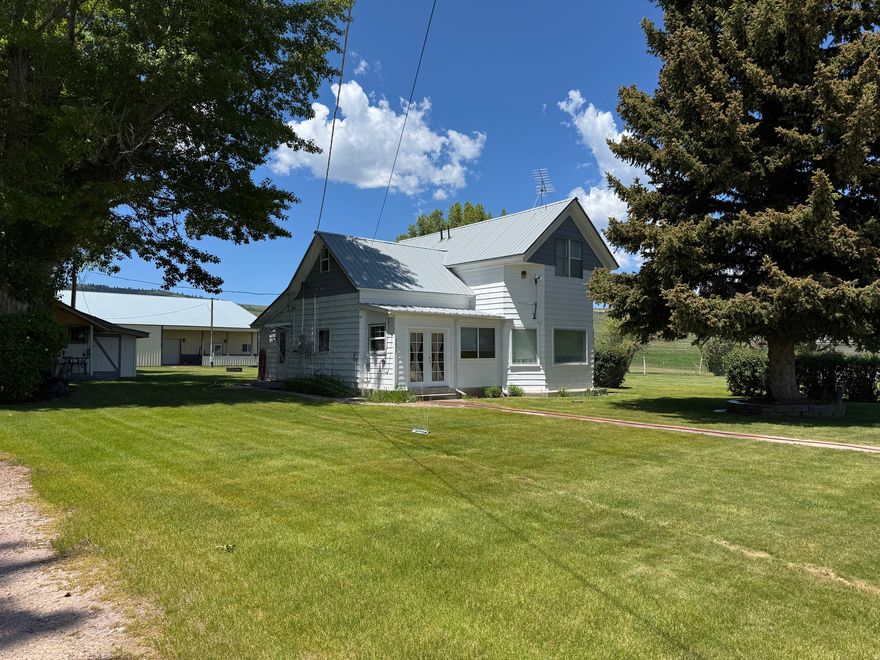 12.4 ACRES Bear LAKE & MOUNTAIN VIEWS. Remodeled Country Home w/enclosed porch. *45x72 CLEARY Building w/power, with 12x42 over-hang and 12x24 enclosed garage. *16x30 SHOP w/Power. *24x32 RUSTIC OLD BARN. *11-acre fenced FIELD w/17X40 DECK & FIRE PIT along the CANAL. *13.5-shares irrigation WATER SHARES. *5-RV Hook-Ups with water/sewer! Perfect FAMILY RETREAT, horse property, mini-farm, or possible subdivision in quaint/quiet FISH HAVEN. Access to FOREST for ATV/Groomed SNOW TRAILS. Bear Lake State Park MARINA or North Beach State Park 9 miles.
