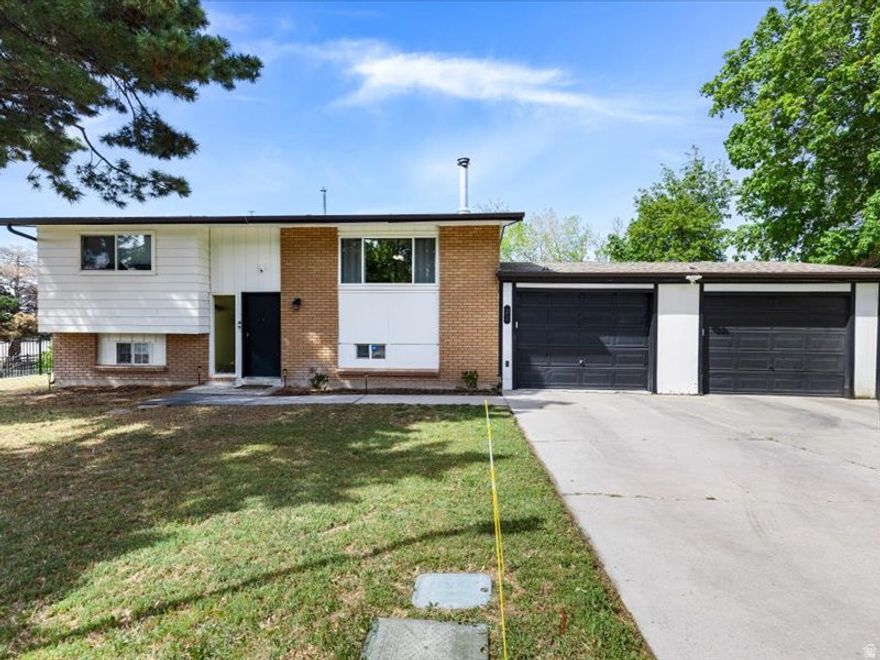 Welcome to this beautifully maintained 5-bedroom, 2-bath split-level home, ideally situated on its own private street. With ample parking, it's perfect for hosting gatherings and special events. The spacious deck is ideal for barbecues, while the pergola offers a comfortable and inviting space to relax and entertain guests. Set on a fully fenced 0.19-acre lot, the backyard provides plenty of room for kids and furry friends to play safely. The home also features a spacious two-car garage, upgraded with automatic doors.  Inside, you'll find 1,406 square feet of thoughtfully designed living space. The upper level features a bright and open living room that flows seamlessly into the kitchen. A large front window fills the space with natural light, while the fireplace creates a cozy atmosphere during chilly winter months. In the summer, enjoy the comfort of air conditioning and a ceiling fan. Upstairs includes a full bathroom with a modern anti-fog mirror, along with two bedrooms, including a spacious primary bedroom. Downstairs, the fully finished basement offers three additional bedrooms, a  bathroom, and a versatile den-perfect for a second living area, office, or playroom. The laundry room comes complete with a washer and dryer for added convenience. Located within walking distance of Sterling Elementary and St. Marguerite School, this home also offers quick access to outdoor recreation. Enjoy a short drive to Oquirrh Hills Golf Course, just minutes away-even close enough for a golf cart ride.