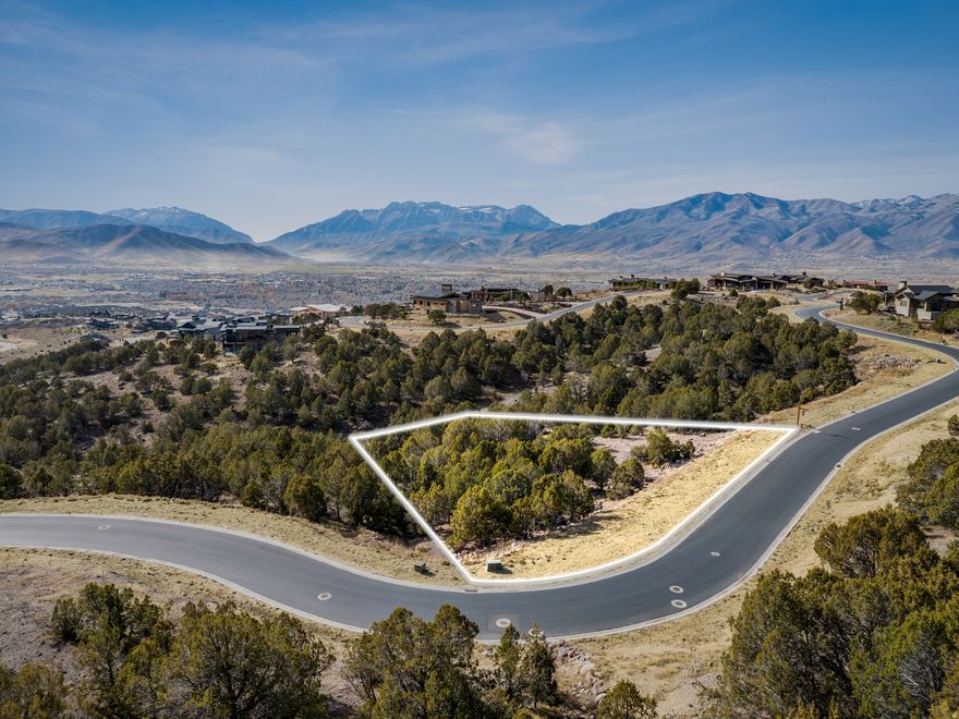 Tucked quietly among mature juniper trees, this 1.25-acre homesite offers a rare opportunity to create an architecturally stunning mountain retreat within the gates of Red Ledges, one of Utah's most coveted private communities. Designed for those who value privacy, sophistication, and connection to nature, this property provides a serene backdrop framed by sweeping mountain and valley vistas.  A Lifestyle Membership is available, granting access to an extraordinary collection of club amenities, a luxury clubhouse, state-of-the-art wellness and fitness facilities, fine dining, tennis and pickleball courts, and the Red Ledges Village Center pools. Outdoor enthusiasts will appreciate proximity to Deer Valley's East Village and Park City's world-class ski resorts, just minutes away.  This home site's natural setting among the junipers ensures privacy and tranquility while remaining close to all the conveniences and curated experiences that define life at Red Ledges.