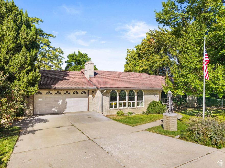 LOCATION, VIEWS, PRIVACY & SPACE! Walking distance to UVU! Charming and spacious 6-bedroom, 3-bath home on a .25-acre lot. This home is well-maintained, custom-built, and cherished by the same family for 52 years-full of potential and ready for new memories. Full brick exterior and tile roof with a life expectancy of 50-75 years.  Darling arched front windows add distinction and charm. Freshly painted with updated LVP flooring throughout most of main floor and new plush carpet/pad. New (Dec 2024) furnace and A/C 16 Seer with heat pump for optimal performance!  Water heater is only a few years old.  Enjoy main floor living filled with natural light and offering an open kitchen and dining area, a large living room wth a fireplace,  3 bedrooms/ 2 bathrooms. Step out from the dining area to an expansive wrap-around deck with partially covered space-perfect for taking in beautiful Utah Lake views, enjoying quiet mornings, or hosting evening gatherings. The basement boasts a large family room, 2nd  fireplace,3 additional bedrooms, one full bathroom, abundant storage, and a large unfinished interior space suspended under the garage, offering endless possibilities. Beneath the extra-deep suspended garage, a hobby/workshop space offers incredible flexibility for future use. The walkout basement opens to a large patio, partially enclosed beneath the deck, leading to an additional workspace/storage room. With 3 separate walkout entrances to the backyard, the basement is ideal for multi-use living or even ADU/accessory dwelling potential. Outside, enjoy a park-like yard with mature trees that provide privacy/shade. Conveniently located just minutes from UVU, freeway access, shopping, and schools, this charming property is nestled in a quiet neighborhood with friendly neighbors.  Also for sale is an adjacent 0.23-acre lot to the north (560 S 880 N)-MLS # 2115593. Contact agent for more information.
