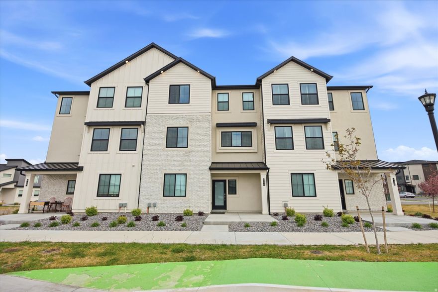 Welcome to this pristine, immaculately maintained townhome in the heart of American Fork, where thoughtful upgrades and modern comfort come together seamlessly. The open-concept layout is elevated by 9-foot ceilings, extended-height cabinetry, and a stunning custom high-end fireplace that anchors the main living space with warmth and style. Just off the kitchen, a versatile flex room with a window offers the perfect opportunity for a home office, guest space, or easily functions as an additional bedroom. Designed for both comfort and efficiency, the home features a 3-zone upgraded HVAC system for targeted climate control, a water softener, and upgraded electrical with 240V in the oversized 2-car garage-ideal for EV charging. Every detail has been carefully considered, creating a truly move-in-ready home in a highly desirable area close to shopping, dining, and continued growth throughout Utah County.