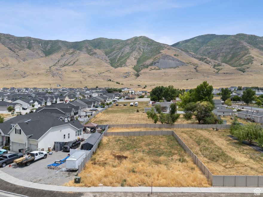 Rare Buildable Lot with Mountain Views and Easy Access to Salt Lake City. Discover a unique opportunity to own a fully fenced 0.18-acre lot in the quiet, established community of Lake Point-no HOA and stunning mountain views right from your future backyard. This peaceful setting offers the perfect balance between rural charm and city convenience, located just 25 minutes from Salt Lake International Airport and downtown Salt Lake City.  Enjoy easy access to I-80, nearby hiking and ATV trails, and the Great Salt Lake-all while being part of a growing, sought-after neighborhood. The lot includes stubbed utilities (water, sewer, power, and internet) and 0.65 water shares, with 0.45 designated for culinary use and the rest ideal for landscaping or trees. The gas line sits approximately 75 feet away on an adjacent parcel owned by the same seller, with permission to extend provided.  This property must be sold in coordination with the nearby duplex (MLS# 2096777), making it a great fit for a combo purchase or a 1031 exchange. A standalone purchase may be possible if closing timelines align.  Vacant land in Lake Point rarely hits the market-don't miss your chance to build your dream home or investment project in one of Tooele County's most promising areas.