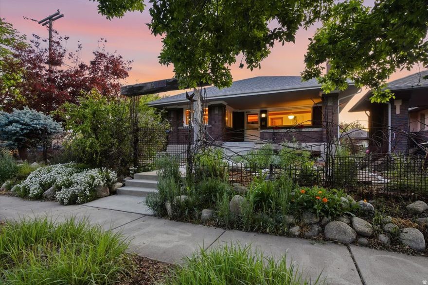 Built to entertain during the Roaring Twenties and passed from one artistic spirit to another, this bungalow shines with the radiance of over a century of good times. It's a treasure trove of original craftsmanship, featuring stately gumwood trim, built-in cabinets with stained glass, and intricate Art Deco light fixtures. Over the years, the home's colorful personality has been further enhanced with unique embellishments: a custom mosaic kitchen window sill and a  glass bottle wall that links the main house to the garage-turned-studio. Outside, a hand-made iron fence covered in mature vines surrounds the yard.   In addition to the home's distinct and lovable character, the property is situated in a premier spot for walkability and urban living: directly across the street from Liberty Park with 80 acres of green space, playgrounds, a public pool, and frequent cultural events; around the corner from the restaurants and shops along 900 South and the new Milk Block; connected to downtown and 9th and 9th via the 9-Line trail. This is a rare opportunity to own a solid, heritage home in a bustling neighborhood that perfectly balances historic charm with future promise.