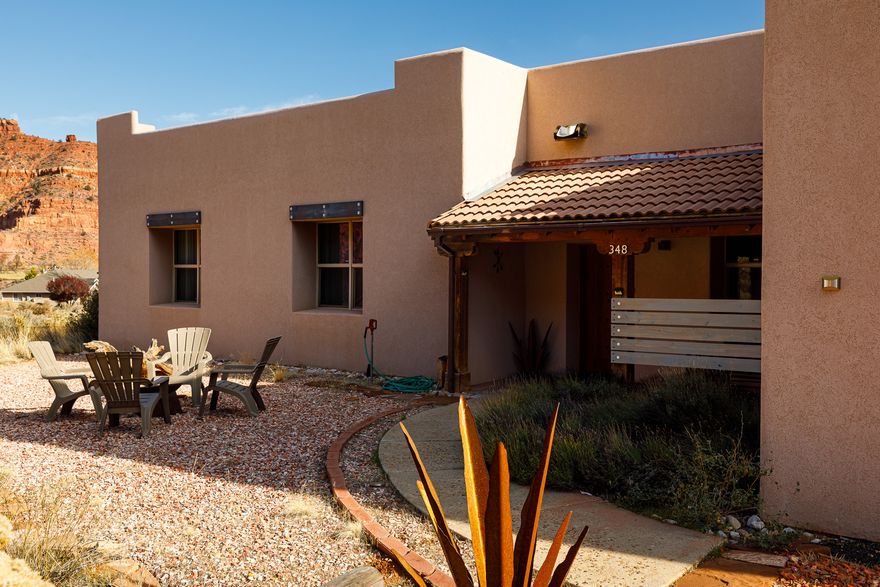 Capturing unobstructed red cliff views from both interior living spaces and outdoor retreats, this Southwest-inspired residence offers 2,197 sq ft on 1.05 acres right in Kanab. Currently operating as a successful, income-producing vacation rental with a solid three-year history, the property is offered turnkey and presents a seamless transition for continued use or a primary residence. Designed to enhance the natural landscape, the home features timeless tile flooring, vaulted ceilings, sky lights, and expansive windows showcasing the legendary Kanab backdrop. The kitchen includes bar seating and connects to a dining area with stunning views. The 3-bedroom, 2-bath floorplan is anchored by a peaceful primary suite with direct patio access and a private sauna. Outdoor living shines with covered and uncovered patio areas overlooking the sunsets, sunrises, starry skies and the Red Cliffs. The acreage accommodates horses, includes fenced pet-friendly areas, and offers a 220 sq ft storage shed. Experience the quiet, open space of desert living with close proximity to trails, recreation, and town conveniences. Buyer to verify all.