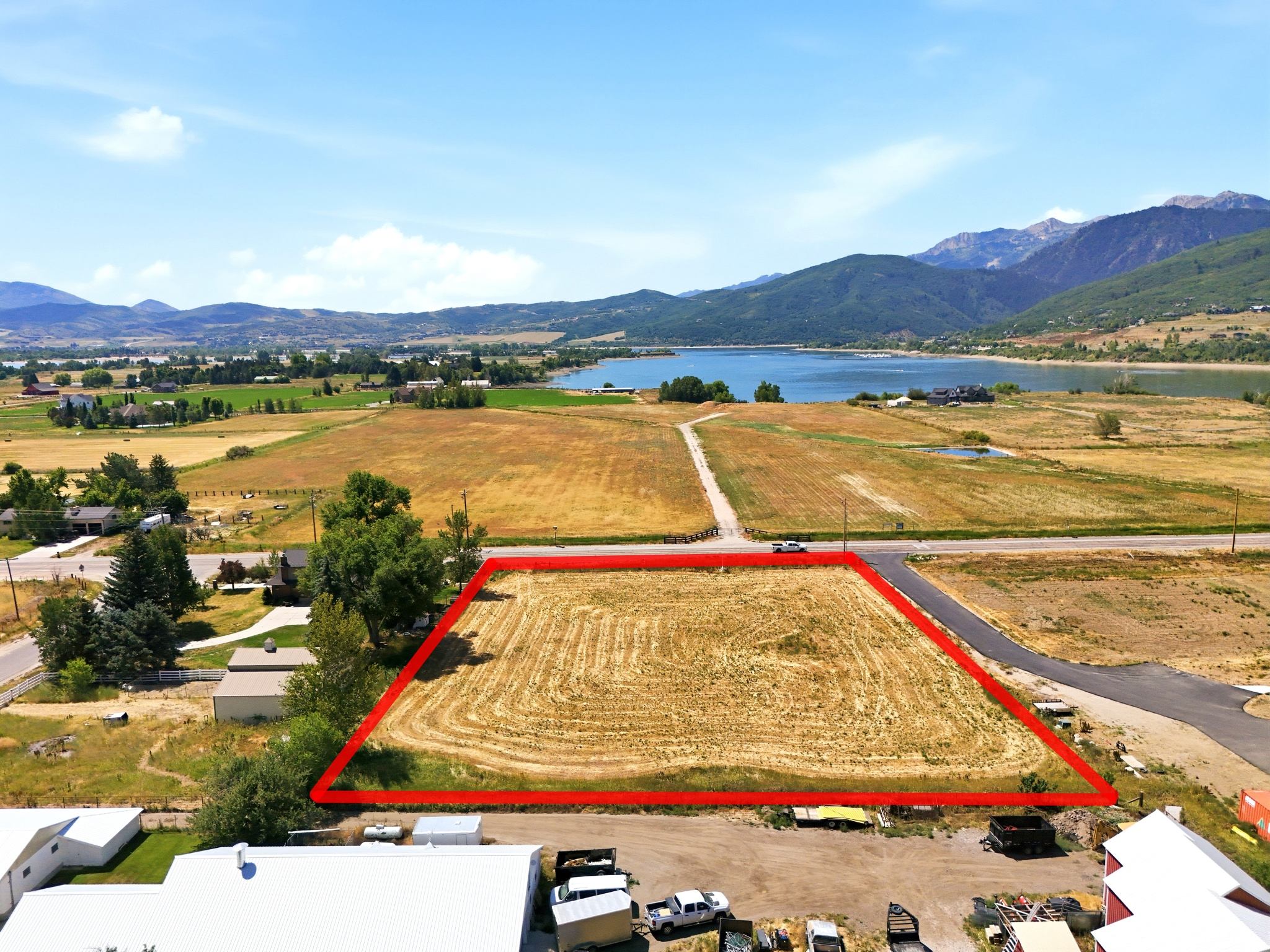 Expansive land parcel featuring direct road frontage and distant mountain and lake scenery