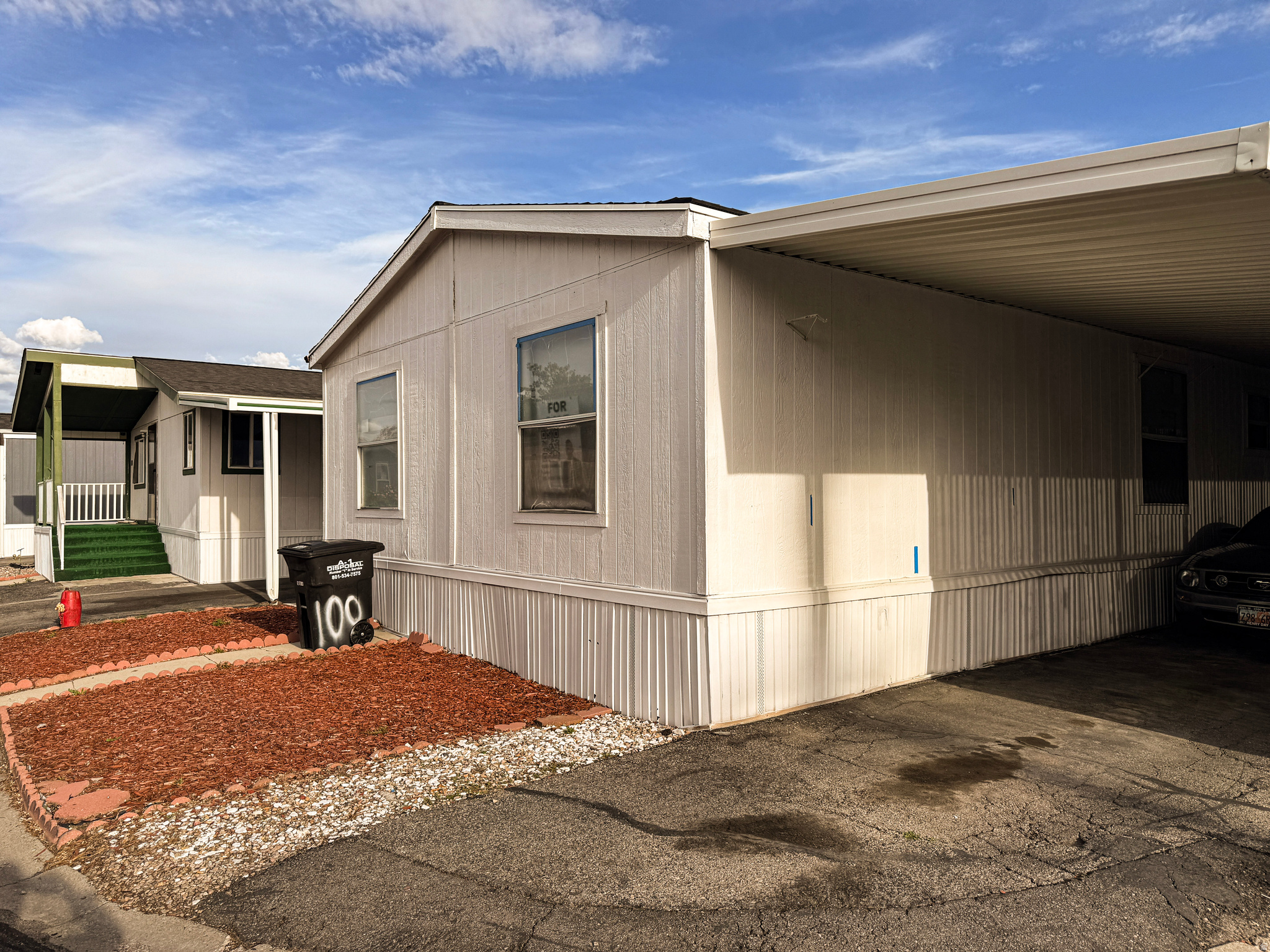 Manufactured home featuring vertical siding and a gabled roofline