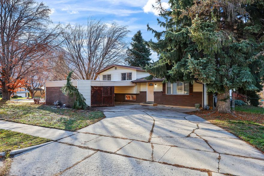 This 4 bedroom home located in North Ogden offers mountain views, mature trees, close access to shopping, transportation, and recreation!  Inside you will enjoy plentiful space in the 2 large family rooms to spend the new year in a new home! The kitchen and dining room flow nicely to the large covered deck out back for you to host guests.  Outside, parking is plentiful with the circular driveway and covered parking, with bonus attached workshop/storage shed.  Located within short walking distance to the canal trail and McGriff Park, you will easily be able to take on the new years goal of more exploring!  Look out the bedroom windows and enjoy full views of Ben Lomond Peak to the North.  This home is located on a quiet horseshoe street with close proximity to Bates Elementary, North Ogden Junior, and Weber High School! Come and take a look at this home today!  Square footage from county records. Buyer to verify all.