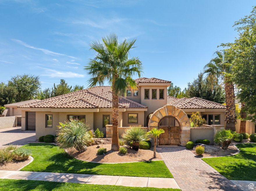 Welcome to this remarkable custom home in the heart of St. George, offering 5 bedrooms, 4.5 baths, an office, and a storage room across 4,547 sq ft on nearly half an acre. A welcoming uncovered courtyard leads you inside to an open-concept floor plan, where a striking water feature, vaulted ceilings, and expansive windows fill the family room with natural light. The gourmet kitchen boasts a large island, walk-in pantry, and high-end Wolfe appliances, while the primary suite impresses with a spa-like bath featuring a walk-in shower, soaking tub, and a dream closet. Entertainment is elevated with a theatre room and bar, while the backyard provides a private resort-style escape complete with a heated pool and spa, built-in BBQ, basketball court, playground, and treehouse-all framed by mature palms and lush landscaping. An oversized 4-car garage with RV parking and a heated workshop adds exceptional convenience. Nestled in an established neighborhood with no HOA, this home perfectly blends luxury, comfort, and lifestyle.