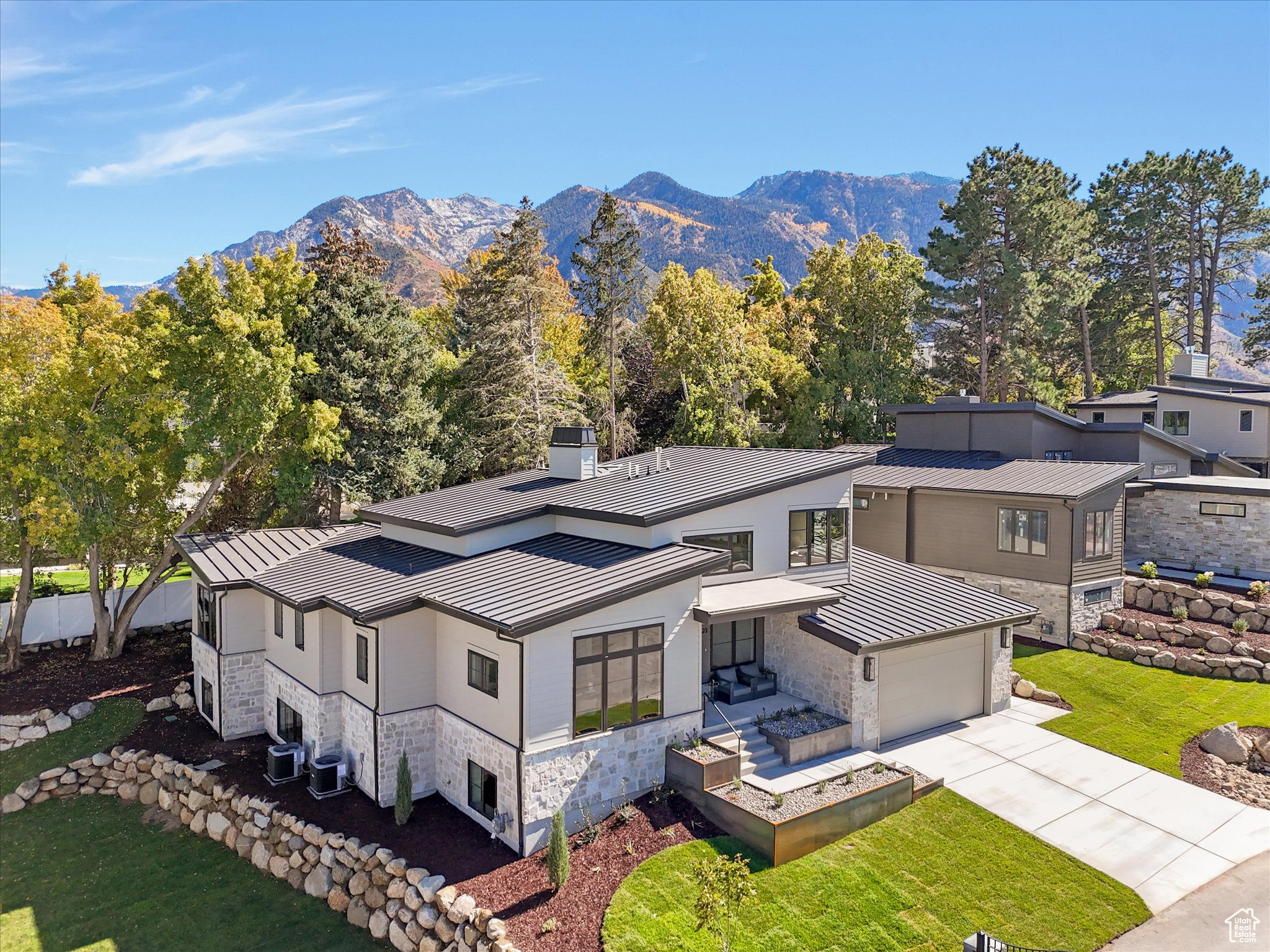 Tucked away in one of Sandy's most sought-after neighborhoods, this stunning 5,248-square-foot residence combines timeless design with thoughtful functionality. With 5 bedrooms, 5 bathrooms, a dedicated home office, and a fitness room, this home offers the perfect balance of comfort and versatility for modern living.The main floor welcomes you with expansive windows and vaulted ceilings that fill the home with natural light. The open-concept layout seamlessly connects the gourmet kitchen, dining, and great room-perfect for entertaining or family gatherings. A spacious primary suite provides a peaceful retreat, complete with a luxurious ensuite bath and walk-in closet. Upstairs, a private loft suite includes a bedroom and full bathroom, ideal for guests or a second home office. The fully finished basement offers even more living space, featuring a large family room, home gym, and additional bedrooms and bathrooms. Set on a quiet cul-de-sac in a beautiful setting, this home offers privacy while remaining close to everything-parks, top-rated schools, outdoor recreation, and the Wasatch Front's world-class skiing and biking.
