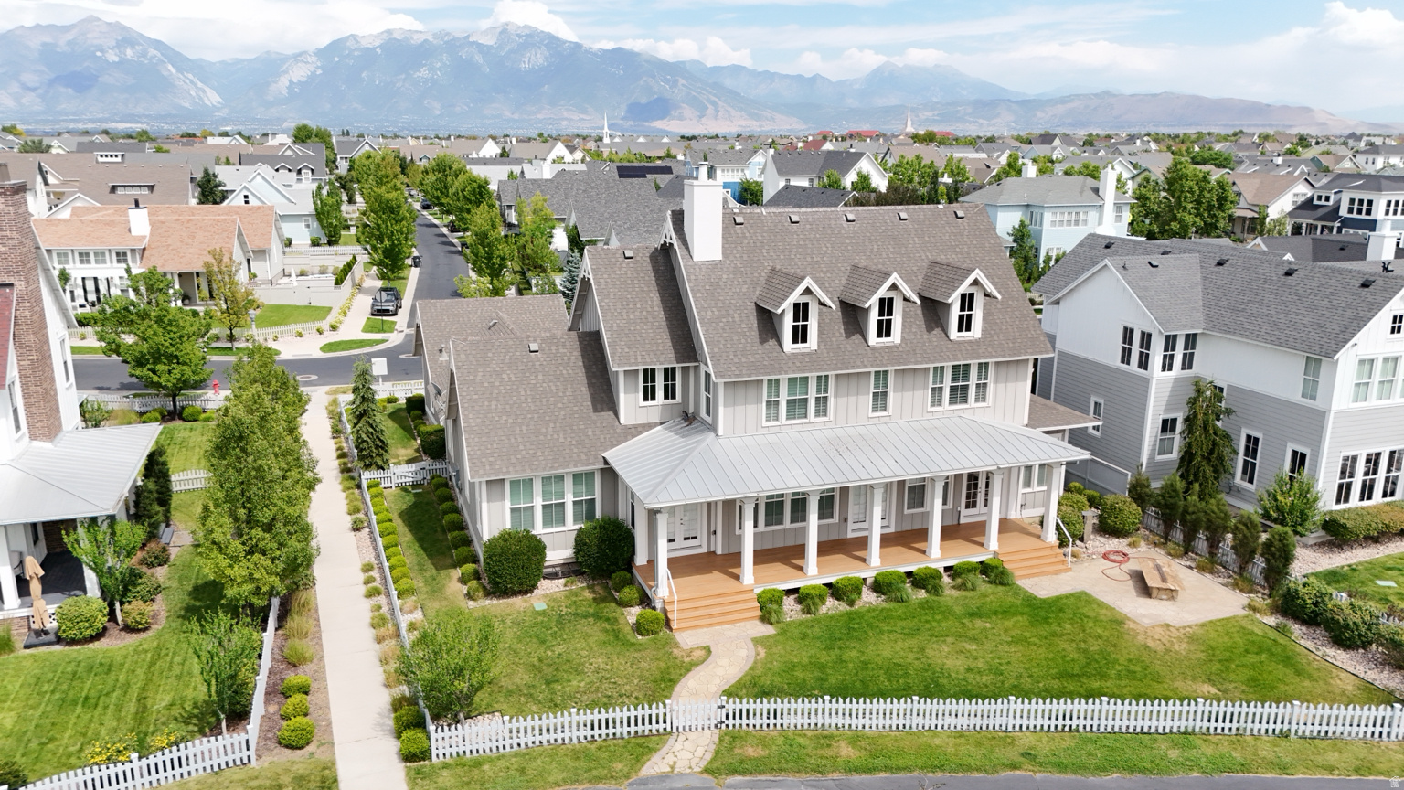 Traditional-style residence featuring a prominent front porch with wood-finish decking