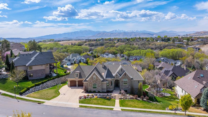 This Stunning Executive Estate (See the Attached Tour Video - Click to See Video), perfectly perched atop the prestigious Highland Hollow, captures breathtaking panoramic views and showcases exceptional craftsmanship throughout its 7,287 sq ft of refined living space. The Main floor welcomes you with a Grand Foyer Entrance, Soaring 1014 ft ceilings, and Large View-Filled Windows that flood the home with natural light, Custom Fireplace with Bookshelves, a Large Open Family, a Gourmet Kitchen with 2 dishwashers, and a Large Dining Space and Pantry. In Addition, a Classy Living Room, an Executive Office with American Cherry Built-ins. The Expansive Master Suite is a true retreat-featuring a Deep-soaking tub, Beautifully Tiled Shower, Travertine flooring, a Massive walk-in closet with a washer and dryer, a Cozy Fireplace, and an attached Sunroom perfect for morning or evening relaxation. The Upper-Level offers a Spacious Loft and anchors a collection of Beautifully Designed 2-bedroom units, each offering comfort, privacy, and elevated views. HUGE Walkout Daylight Basement offers a Fully Finished Walkout Basement that lives like a second home, complete with a Full Gourmet Kitchen, Dining area, Movie Theater Room with a high-end screen and sound system, Game Room, and an additional Family Gathering Room.  Additionally, 3 Bedrooms and 2 Full Bathrooms, and Lots of Storage. This Meticulously Maintained Estate is enriched with premium features, including 2 full-service Gourmet Kitchens, 3 Expansive gathering areas, 3 Fireplaces, and 3 Laundry rooms. Additional Upgrades include Solid Cherry Wood floors, Granite Countertops, High-end Tile throughout, Landscape lighting, Epoxy Garage Floors, a Tankless Water Heater, and a Two-zone AC/furnace system with six thermostats. TVs are also included, adding to the home's move-in-ready appeal. The Location is perfectly situated within walking distance of parks and just minutes from Silicon Slopes, Shopping, Dining, and Freeway access. This Estate offers both convenience and serenity. A MUST SEE.