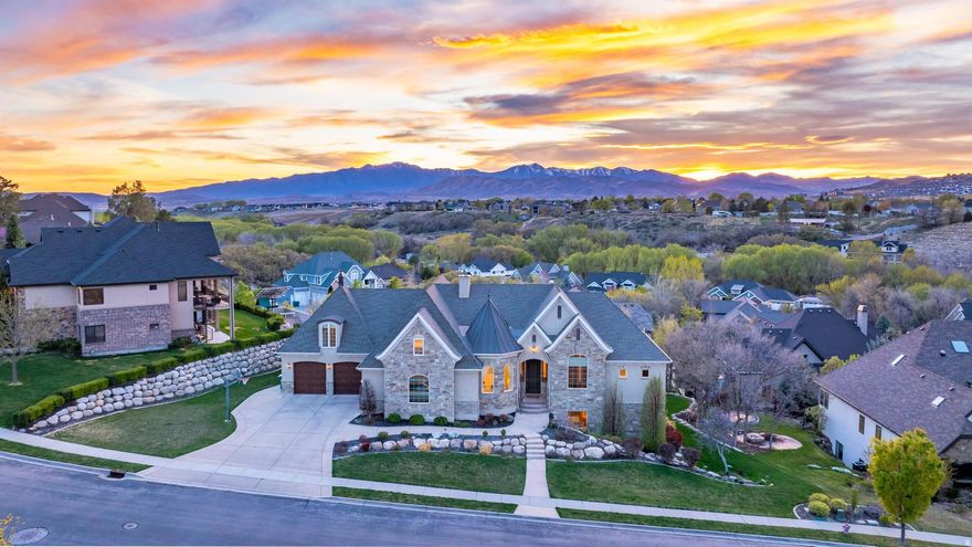 This Stunning Executive Estate, (See the Attached Tour Video) perfectly perched atop the prestigious Highland Hollow, captures breathtaking panoramic views and showcases exceptional craftsmanship throughout its 7,287 sq ft of refined living space. Thoughtfully designed with timeless finishes and an expansive open layout, this custom residence offers unmatched luxury at every turn. From its sophisticated architectural details to its seamless blend of comfort, elegance, and functionality, this home stands as a true masterpiece in one of the area's most coveted settings. The Main floor welcomes you with a Grand Foyer Entrance, Soaring 1014 ft ceilings, and Large View-Filled Windows that flood the home with natural light, Custom Fireplace with Bookshelves, a Large Open Family, a Gourmet Kitchen with 2 dishwashers, and a Large Dining Space and Pantry. In Addition, a Classy Living Room, an Executive Office with American Cherry Built-ins. The Expansive Master Suite is a true retreat-featuring a Deep-soaking tub, Beautifully Tiled Shower, Travertine flooring, a Massive walk-in closet with a washer and dryer, a Cozy Fireplace, and an attached Sunroom perfect for morning or evening relaxation. The Upper-Level offers a Spacious Loft and anchors a collection of Beautifully Designed 2-bedroom units, each offering comfort, privacy, and elevated views. Walkout Daylight Basement offers a Fully Finished Walkout Basement that lives like a second home, complete with a Full Gourmet Kitchen, Dining area, Movie Theater Room with a high-end screen and sound system, Game Room, and an additional Family Gathering Room.  Additionally, 3 Bedrooms and 2 Full Bathrooms, and Lots of Storage. This Meticulously Maintained Estate is enriched with premium features, including 2 full-service Gourmet Kitchens, 3 Expansive gathering areas, 3 Fireplaces, and 3 Laundry rooms. Additional Upgrades include Solid Cherry Wood floors, Granite Countertops, High-end Tile throughout, Landscape lighting, Epoxy Garage Floors, a Tankless Water Heater, and a Two-zone AC/furnace system with six thermostats. TVs are also included, adding to the home's move-in-ready appeal. The Location is perfectly situated within walking distance of parks and just minutes from Silicon Slopes, Shopping, Dining, and Freeway access. This Estate offers both convenience and serenity. A MUST SEE.