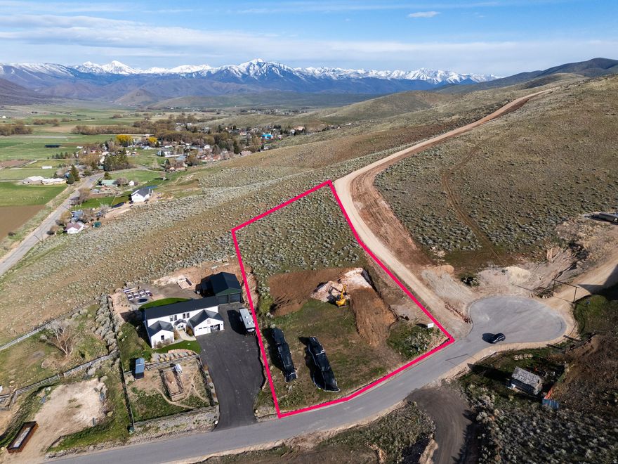 Create your dream home on this exceptional 1.46-acre lot, offering breathtaking mountain and valley views by day and stunning, star-filled skies at night. Nestled in the peaceful community of Wallsburg, this property provides a rare combination of quiet country living and convenient access-just 20 minutes from Provo and Heber City.  Wallsburg delivers true small-town charm while keeping you close to everyday essentials and year-round recreation. In the warmer months, enjoy nearby golfing, boating, fly fishing, and water sports at Deer Creek and Jordanelle reservoirs, along with easy access to scenic hiking and biking trails. When winter arrives, world-class skiing and snowmobiling await just minutes away at renowned resorts like Sundance, Park City, and Deer Valley.  This is the only shovel-ready lot currently available in Wallsburg. Situated on a paved cul-de-sac, the property includes city water, electricity, and a completed septic perc test-making it ready for immediate construction.  Plans are available for a stunning 4-bedroom, 3,200 sq. ft. farmhouse-style home featuring a 4-car garage and a wraparound porch designed to capture the incredible views. The spacious lot also offers ample room for additional structures such as workshops, garden sheds, or coops.  Animal rights are included, giving you the freedom to keep horses and fully enjoy the rural lifestyle.