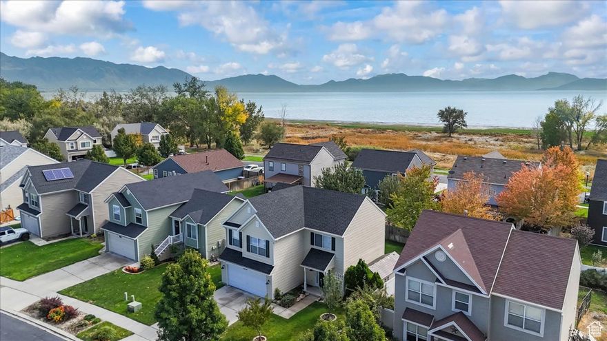 Utah Lake Community! 1832 sq ft + 184 sq ft enclosed patio = 2016 sq ft of an opportunity to live in a unique lakefront community with ponds, widlife, parks and trails! Why live in a standard "tract" setting when you can enjoy Utah Lake nature at it's best along with an adjacent park...& with NO HOA fees. Nothing but peaceful living in a development that rarely has this 4 bdrm model for sale. Community park across the street, peaceful pond and recreational area one street over, lakeside walking paths, this is what you have been looking for! New roof, new siding (on some sides), newer HVAC & water heater. All of the "upkeep" work is done...all ready to move in and relax.  "Single Family Detached Housing" at "Townhome pricing"...and NO HOA!