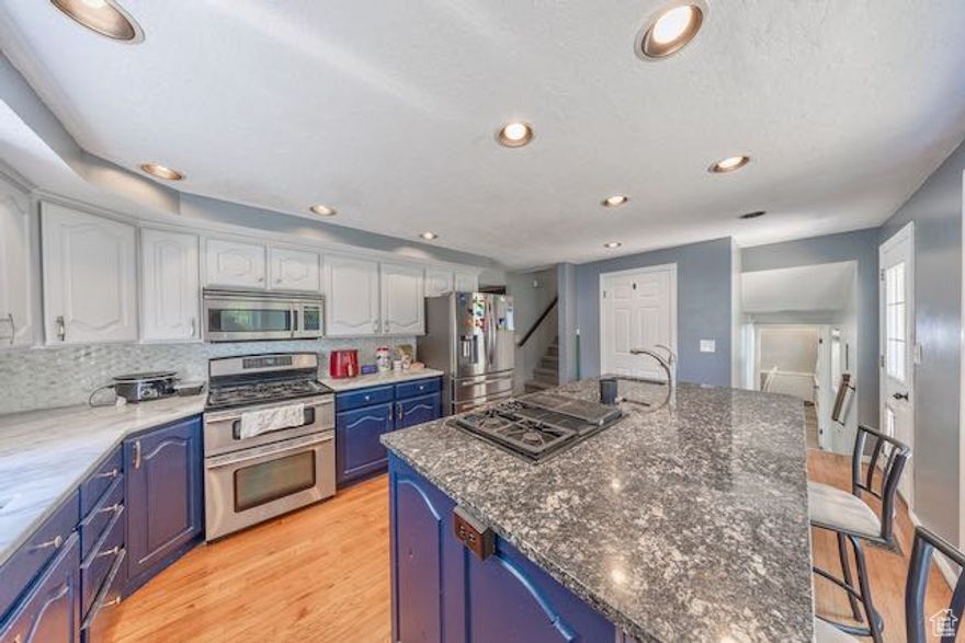 *** BANK-APPROVED PRICE. ***  Convenient Syracuse location!    Kitchen features newer granite and quartz counter tops and backsplash, newer dishwasher, double oven range.   Second gas cooktop and sink at island.   Stainless steel appliances.   Lots of kitchen cabinets.  Fridge stays.  Gorgeous fireplace.  Beautiful hardwood flooring.  Nest doorbell, smart thermostat, outdoor security cameras, newer furnace and paint throughout this lovely home.  27' RV parking.  Covered rear patio 11' x 20' and great for BBQs or relaxing outdoors.  Fully fenced yard.  Large backyard shed 16.5' x 10' for more storage.   Near shopping, schools, commute, Hill AFB, Antelope Island, golfing, lakes, camping, and more. 30 minutes to SL Airport.  LOTS of options with this home!  Come tour and send your offer today! Call for more info today!