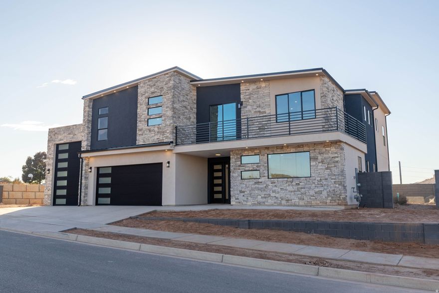 Brand-new modern 2-story by Next Level Homes on an elevated lot with red rock views. 3,700+ sq ft, RV garage, main-floor guest suite, big great room + butler's pantry. Upstairs primary w/ sitting area, loft w/ kitchenette plumbing, and view deck.