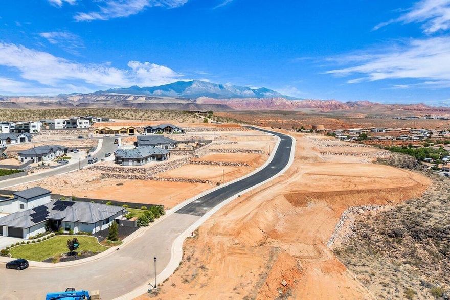 Premier rim view lot with exceptional views overlooking the city, mountains, Pine Valley, red rock mesas, Sand Hollow, and even Zion National Park! Best suited for a walkout floor plan, this lot is located in the final phase of Grand Heights, the highest elevated subdivision in St. George proper, nearly 500 feet higher than the rest of town, including Stone Cliff and Foremaster, offering unmatched views. Enjoy quick access to downtown, hiking and biking trails, and off-road adventures, plus you're just 15 minutes from two major fishing reservoirs and over half a dozen top-rated golf courses. With BLM land bordering the subdivision, you can ride bikes and ATVs straight from your doorstep. Numerous oversized lots are available with convenient highway access. Bring your own builder! Buyer is responsible for water impact fees. All construction requires prior review and approval by the architectural control committee. Buyer to verify all information, deemed reliable, however buyer to verify all info including utilities & ACC information if applicable.