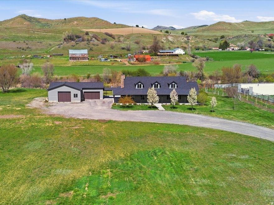 Once in a Lifetime Property!!  5 Acres along the Bear River with Beautiful Custom 5 Bedroom Home Built in 2016 with Detached Garage and 6 Water Shares!!  This is THE DREAM property that you've waited and watched to hit the market.  This custom-built home with wrap around porch captures the feel of the country and set off the road and backing the Bear River it's the perfect retreat.  The home and garage are fully foam insulated every part of the home was custom designed with open kitchen, granite countertops, custom cabinetry, large master suite with separate shower and soaking tub.  Two furnaces and two air conditioners for the home making it energy efficient.  The large, detached garage is heated and cooled with private office overlooking the river.  There are 7 220 plugs and overhead air compression in the garage.  This is the perfect set up!!  You MUST SEE to appreciate this property!!  Come RETREAT from the city, float the Bear River with your family and enjoy the privacy of this BEAUTIFUL 5 Acre Property!!  This is THE DREAM property that you've waited and watched to hit the market!!  There is also an option to potentially subdivide off 2.5 Acres for another building lot as well.  Call Agent for Details and Come See!!