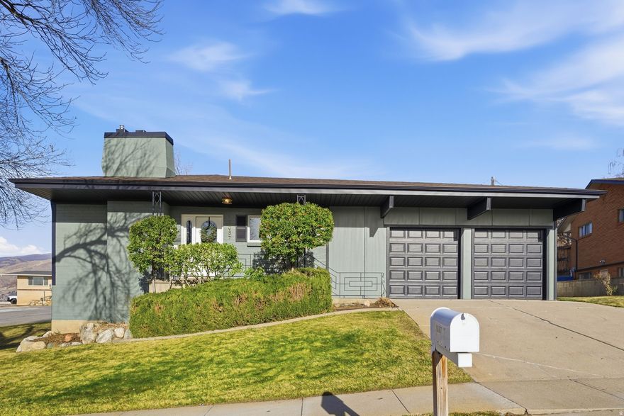 Come home to this wonderful neighborhood that is walking distance from schools, parks, trails, and churches as well as just 15 minutes from Salt Lake City. This stunning home is situated on a corner lot and has been wonderfully updated throughout. When you first walk in you will notice the wide-open space of the living room, dining room and beautiful kitchen. The living room has a custom fireplace and large picture windows so you can relax and enjoy the spectacular views of the Valley, the mountain and nightly sunsets. The primary en-suite features a double vanity, storage shelves and is beautifully tiled. The basement has two large bedrooms with huge walk-in closets plus spacious and thoughtfully designed laundry room, a family room and a full bathroom. The outdoor space is fully fenced and perfect for entertaining. Square footage figures are provided as a courtesy estimate only and were obtained from County Records. Buyer is advised to obtain an independent measurement.