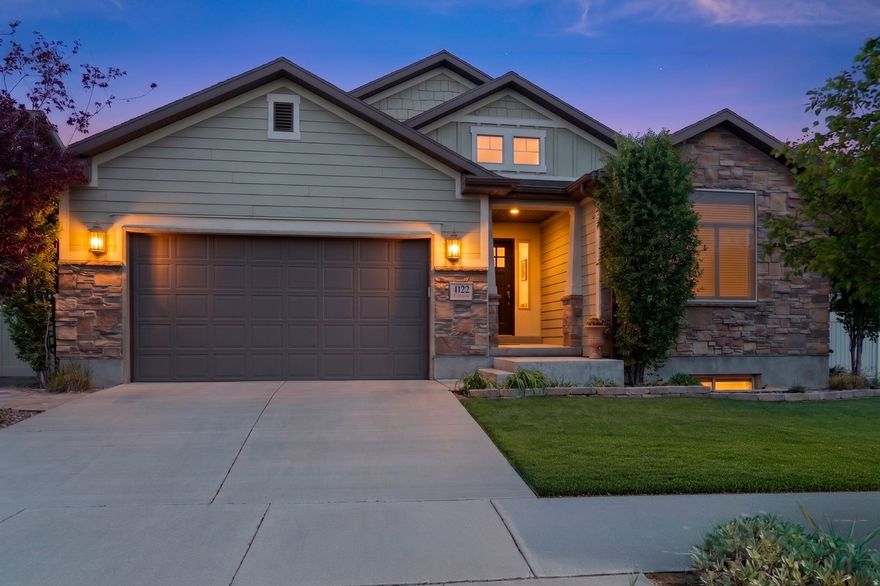 Step into perfectly located comfort and convenience at 4122 Walnut Canyon Ln, a meticulously maintained home nestled in a perfectly valley-central, desirable South Jordan neighborhood. Ideally located just outside Daybreak-without being within its boundaries or its HOA fees -this property offers the benefit of low HOA fees, amazing proximity to premier amenities, freeway entrances, shopping, health clubs, and dining while maintaining added flexibility and fewer restrictions. Close to everything, quiet, private neighborhood, and centrally located. The gem you've been waiting for!  The home features a functional, warm layout designed for everyday living and entertaining, with generous natural light and inviting living spaces indoors and out. The main level offers an open-concept design from the extra wide entry welcoming you all the way through to the connecting living room, dining area, and kitchen with beautiful, polished, carved wood flooring under your feet; creating an ideal gathering space under the spacious vaulted ceiling. The kitchen includes ample cabinetry and workspace, closet pantry, along with several thoughtful upgrades and designer touches that add style, character, and warmth.  On the main floor, you'll find spacious bedrooms, including a primary suite with vaulted ceiling, a private jetted bath and walk-in closet. Throughout the home, you'll notice additional upgrades and finishes that set it apart and give it a more polished, move-in-ready feel. With virtually all light switches and fans "smart-upgraded", you'll be ready to control the entire home with your voice or phone.  The unfinished basement provides excellent flexibility-perfect for storage or a workout space now or ready for your own custom finishing touches in the future. The oversized, deep, and numerous basement windows flood it with light, removing any concerns about a basement feel. A perfectly sized concrete "vault" room is ready to be transformed into the perfect wine cellar or gun vault.  Outside, enjoy the personal quite oasis of a low maintenance, fully turfed, landscaped, and usable yard with space to relax, walk the professional cobblestone paths, garden, or entertain. Let the smart watering system take care of your numerous lush plantings. Outside smart fan and pergola lights will augment your beautiful evenings under an open sky. A perfect private pad for your large hot tub awaits, including existing power! With a low HOA and a convenient location close to parks (a private one included with your HOA), schools, and commuter routes, this home offers a balanced blend of comfort, accessibility, and value in one of South Jordan's most sought-after areas. This one will not last!