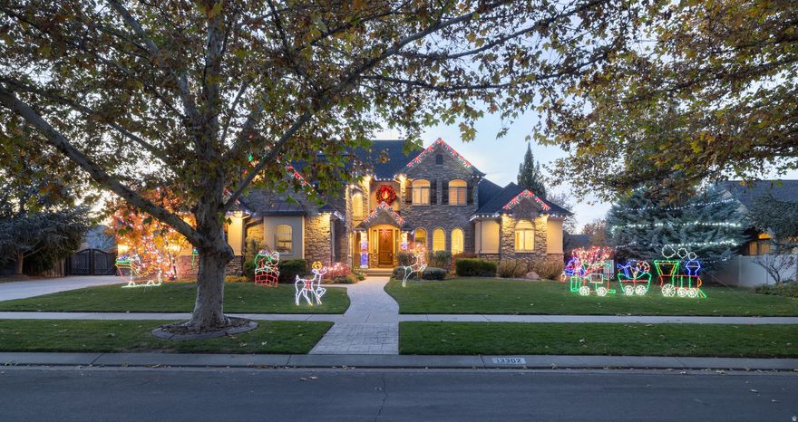 The Perfect Place to Call Home for the Holidays and Every Season After! Nestled in Draper's prestigious Corner Crossing neighborhood, this beautifully designed 6-bedroom, 5-bathroom home offers a perfect blend of timeless craftsmanship and modern comfort. The residence features rich wood accents -including custom cabinetry, detailed trim, and travertine flooring throughout the main level. Enjoy effortless entertaining in the finished lower level, complete with a custom wet bar and direct walk-out access to the backyard, creating an indoor-outdoor flow for gatherings. Set on a spacious lot with mature landscaping, this property offers the perfect blend of privacy and curb appeal. Enjoy your own heated swimming pool, a pergola-covered fire pit lounge area, and ample patio space-ideal for relaxing or entertaining year-round. With generous living areas, a functional floor plan, and a welcoming neighborhood setting, this home is ideal for everyday living. Additional highlights include a generous 4-car garage with epoxy floors, RV parking, and a large main-floor laundry room. Don't miss the opportunity to own a home that feels like a private retreat while still being close to schools, shopping, dining, and canyon trails.