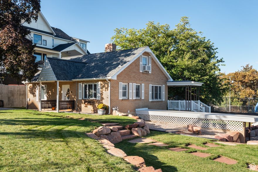 Charming East Bountiful home with country charm and city views! Nestled on a private drive, this updated cottage offers beautiful sunset views and a perfect sightline to the Temple. The home features a modern kitchen with quartz countertops, herringbone backsplash, induction range, wood-look tile flooring, and stacked soft-close cabinetry with adjustable lit glass uppers. Updates include a newer 50-year roof, white soffit and fascia, new landscaping and sprinklers, fresh paint, some electrical and plumbing updates, and a remodeled main bath. The basement ADU/mother-in-law suite has been rented almost the entire time seller has owned home, helping pay the mortgage! It has a separate entrance, full kitchen, living room, bedroom, bath, den, luxury vinyl plank flooring, and stackable washer/dryer-ideal for rental income or guests. Enjoy a detached two-car garage as well! *Agent related to seller. Square footage figures are provided as a courtesy estimate only. Buyer is advised to obtain an independent measurement.