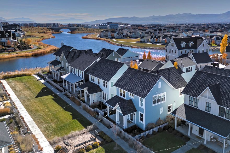 Nestled in the heart of Daybreak, this remarkable home sits just a few steps from the tranquil Daybreak Lake and within easy strolling distance of charming eateries, entertainment, and a variety of activities. Constructed in 2020 and thoughtfully upgraded throughout, it features a chef's kitchen with premium appliances and a sophisticated wet bar complete with a sink and an extra mini fridge-perfect for gracious entertaining. The open, luminous floor plan unfolds to four bedrooms, four bathrooms, and a fully finished basement, offering abundant space and versatility. This home stands as a true standout, adorned with refined finishes and meticulous attention to detail. For additional information or to arrange a private showing, please call today.