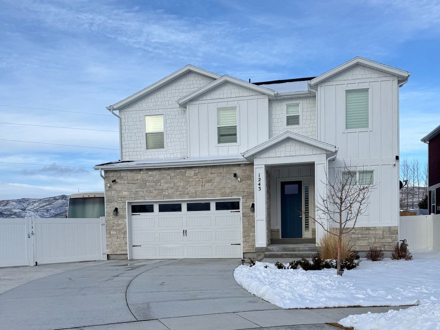 Nestled in the heart of the Brookside subdivision, 1243 S 1040 East offers the perfect blend of Heber City charm and modern convenience. This 3,553 sq. ft. home boasts Views of Timpanogos to the west & the east hills from Your bedroom windows. A bright, airy floor plan featuring a spacious kitchen, large pantry, 3 bedrooms and 3 bathrooms. The exterior is a homeowner's dream: enjoy summer BBQs on the back deck, let the pets roam in the fully fenced yard, or tinker in the garden of your professionally landscaped lot. If you have toys, the RV parking pad is a major bonus. Located in a safe, low-traffic cul-de-sac, this is the ideal spot for those seeking a quiet neighborhood feel without sacrificing space or style. Furnishings available on a separate bill of sale.