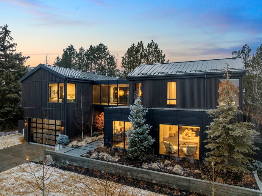 In the heart of Park City's highly sought-after Prospector neighborhood, this newly constructed residence blends striking modern architecture with refined finishes and exceptional everyday livability. Ideally located within walking distance to McPolin Elementary and Park City High School, the home also enjoys effortless access to local dining, boutique shopping, neighborhood parks, and miles of year-round trail systems. A dramatic floating staircase creates an immediate architectural statement, setting the tone for the home's sophisticated contemporary design. Walls of glass are thoughtfully positioned throughout, bathing the interiors in natural light from sunrise to sunset while framing the surrounding landscape. At the center of the home, the chef's kitchen is both functional and impressive - anchored by multiple islands, premium appliances, and a seamless connection to the expansive great room. Designed for entertaining, large sliding glass doors extend the living space outdoors to a private walkout patio, creating a true indooroutdoor experience ideal for hosting and gathering. Four spacious ensuite bedrooms offer comfort and privacy for family and guests alike. The primary suite is a true retreat, featuring a spa-inspired bath and an oversized walk-in closet designed with intention and scale. The garage offers exceptional flexibility, with ceiling height that allows for the installation of a vehicle lift - creating the potential for a four-car configuration, ideal for collectors or those seeking additional storage and versatility. Outside, a fully fenced, flat yard provides rare in-town usability - perfect for children, pets, or simply enjoying Park City's mountain air. This is a rare opportunity to own a newly built, design-forward home in one of Park City's most convenient and established neighborhoods.